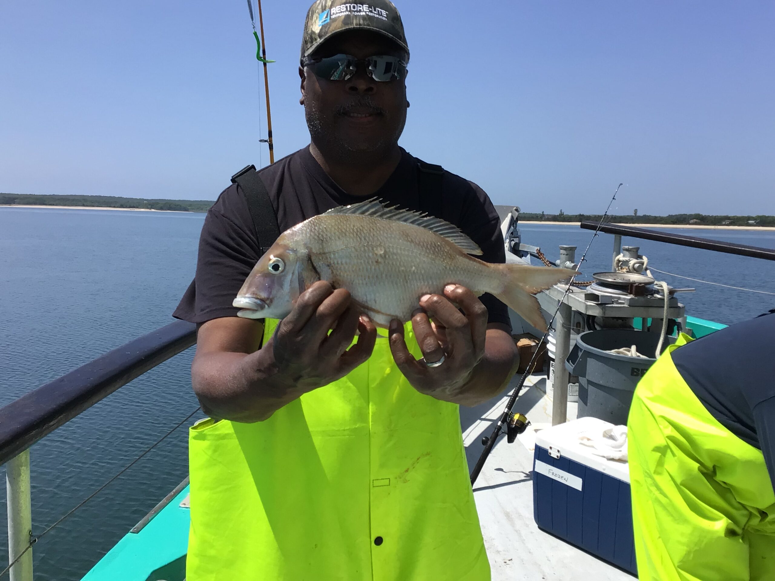 a person holding a fish in the water