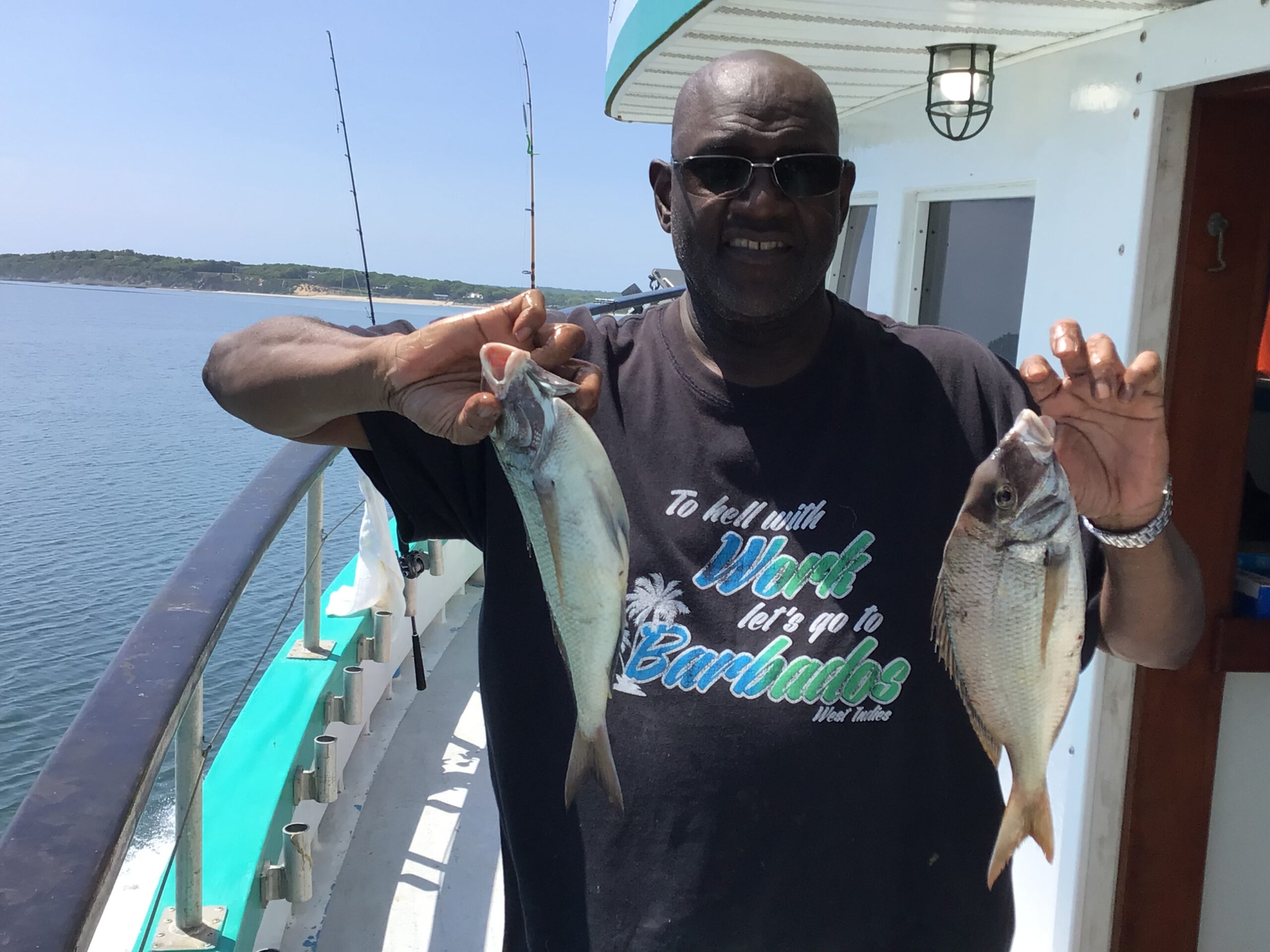 a person holding a fish on a boat