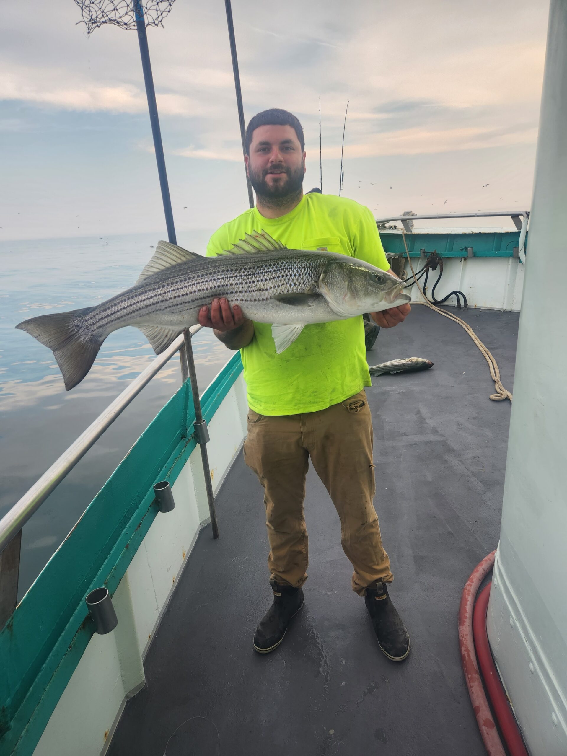 a man holding a fish in the water