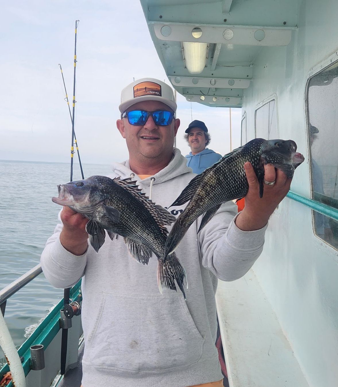 a person holding a fish on a boat