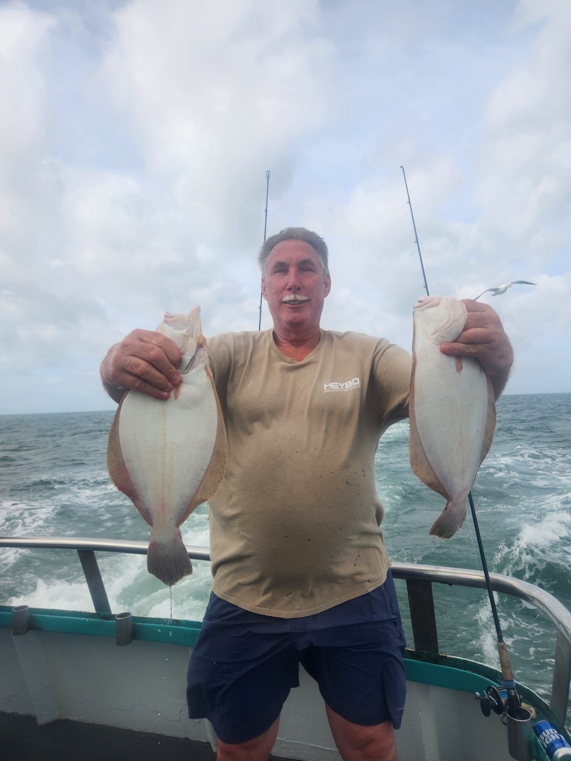 a man holding a fish in the water