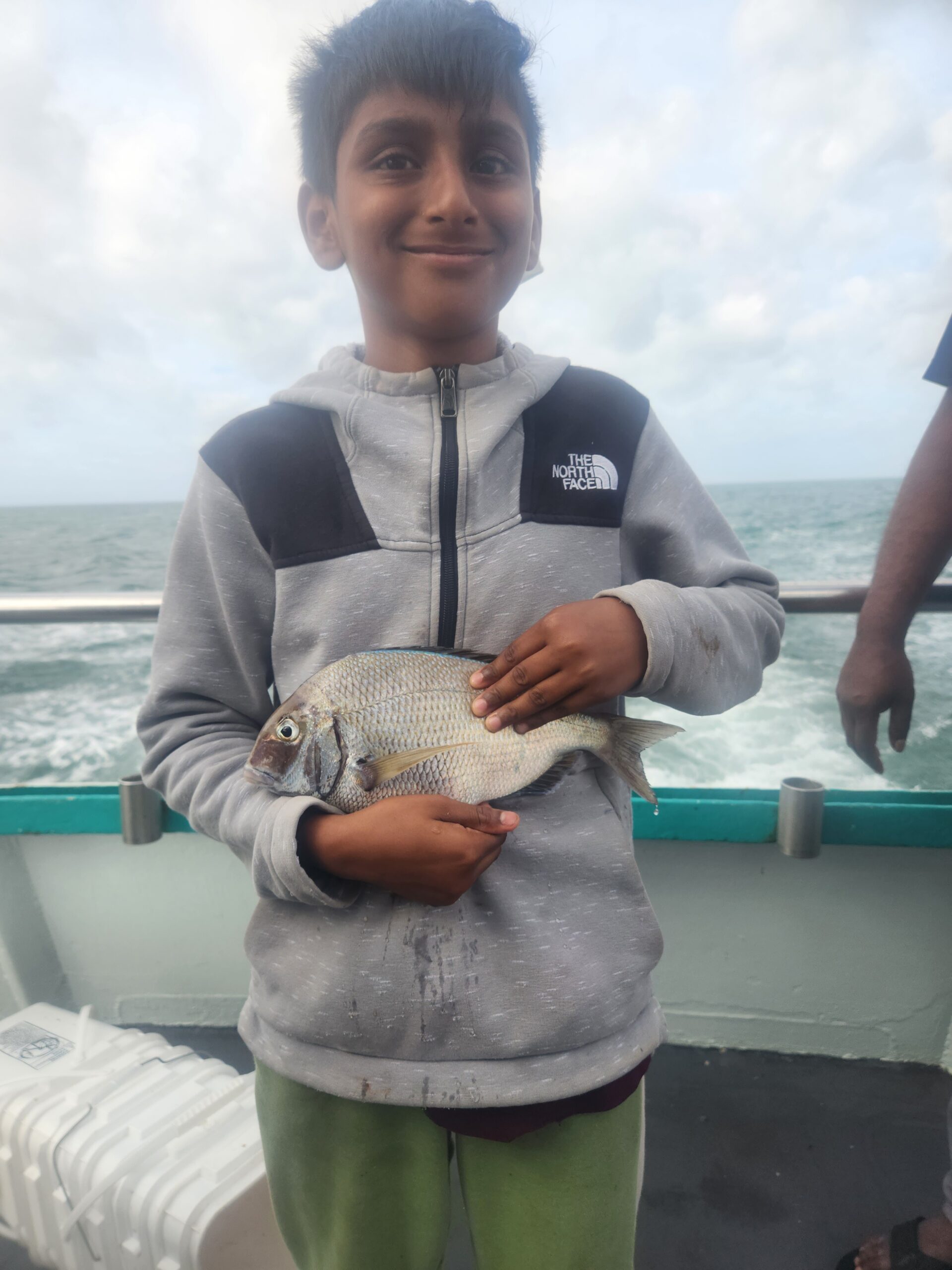 a person holding a fish in the water