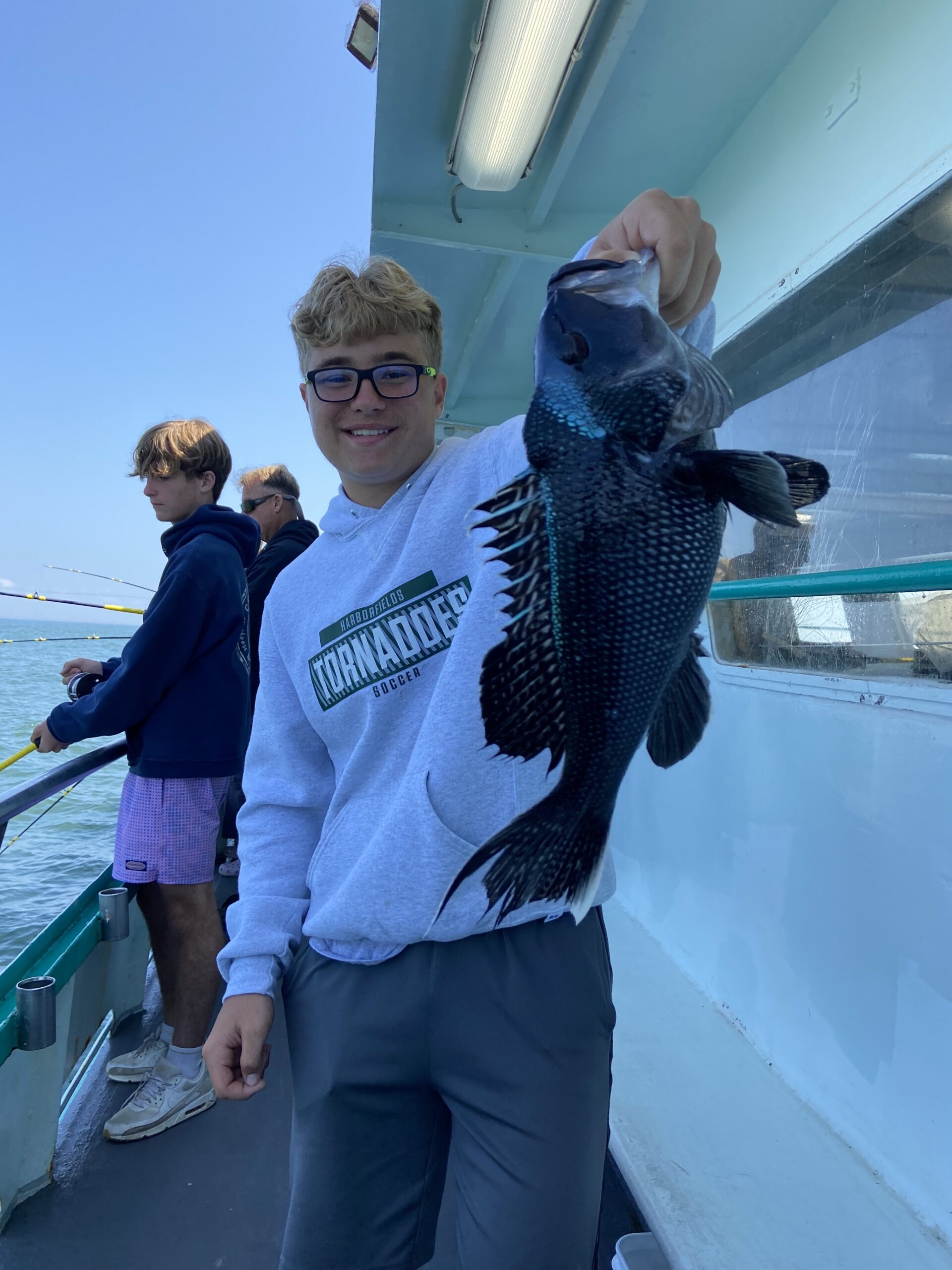 a man standing next to a teddy bear
