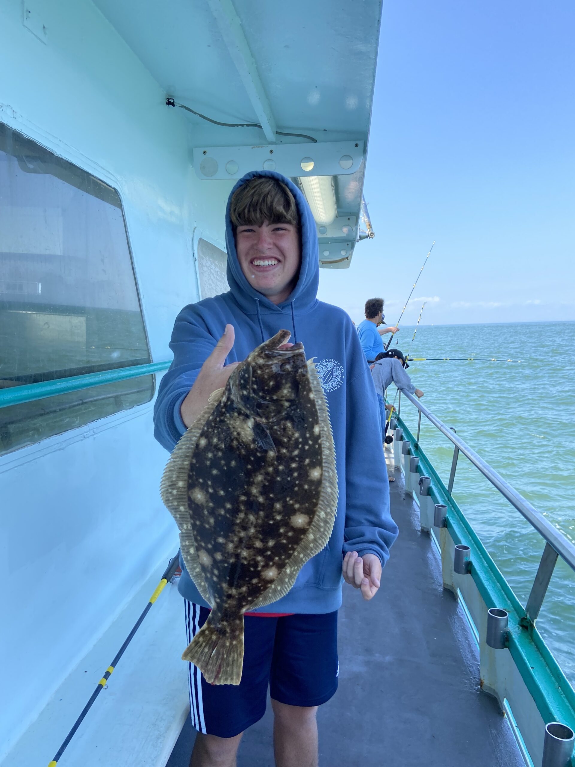 a person holding a fish on a boat in the water