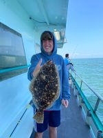 a person holding a fish on a boat in the water