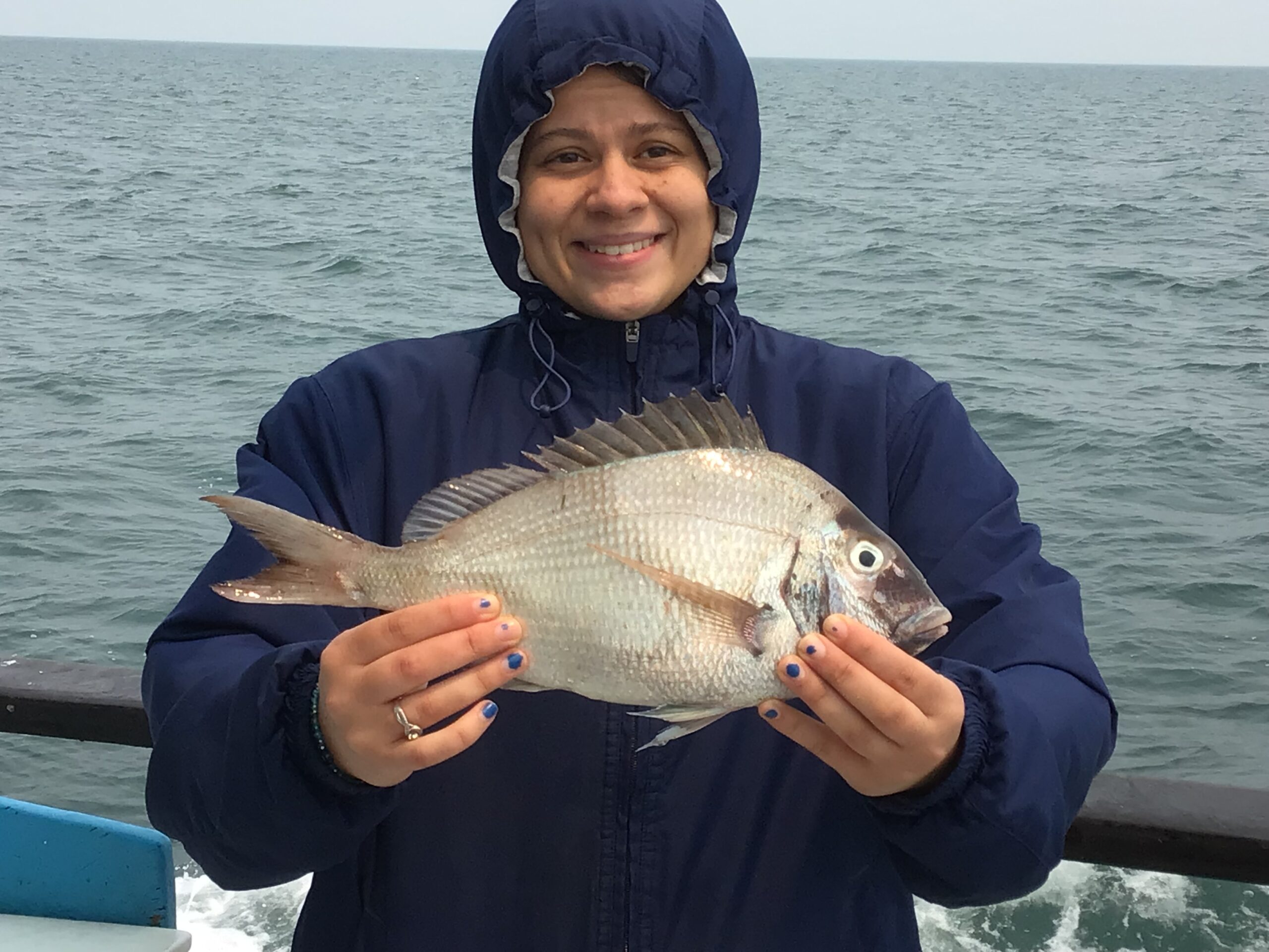a person holding a fish in the water