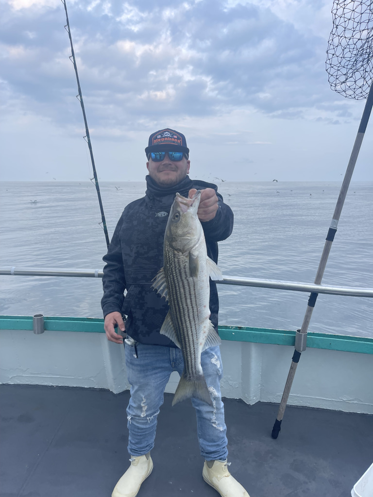 a man standing next to a body of water