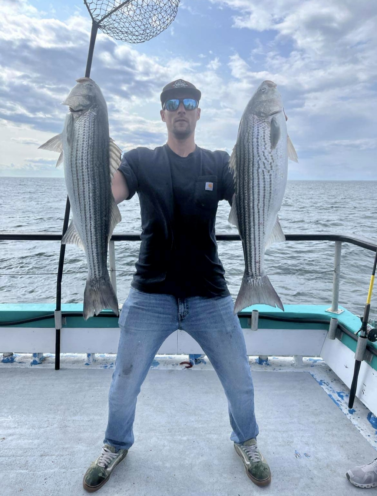 a man holding a fish in the water