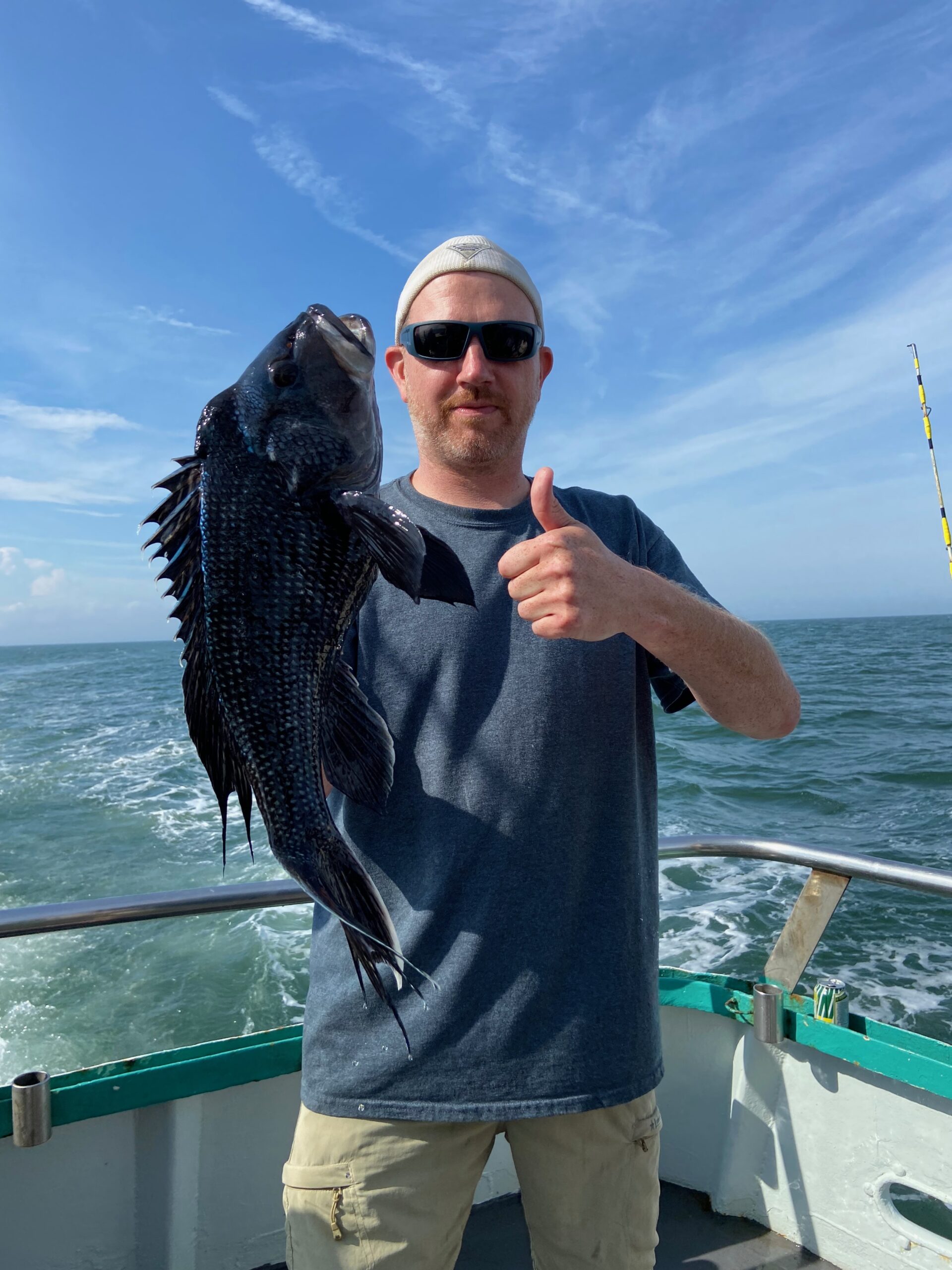 a man holding a fish in the water