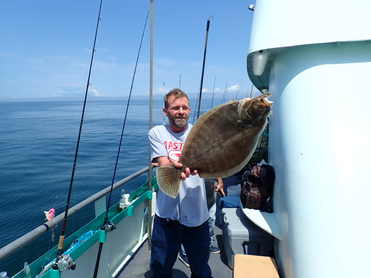a person holding a fish on a boat