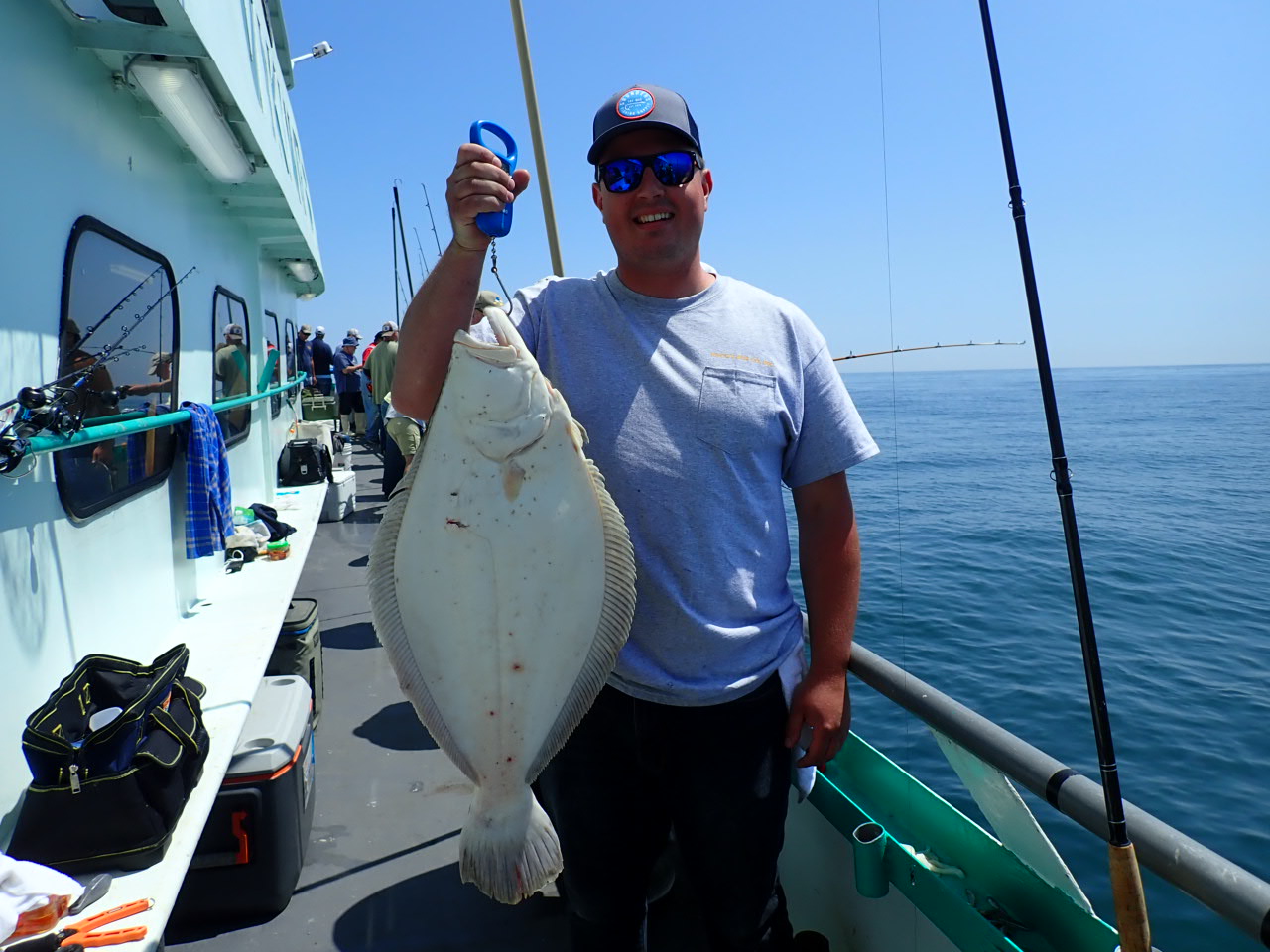 a man holding a fish on a boat