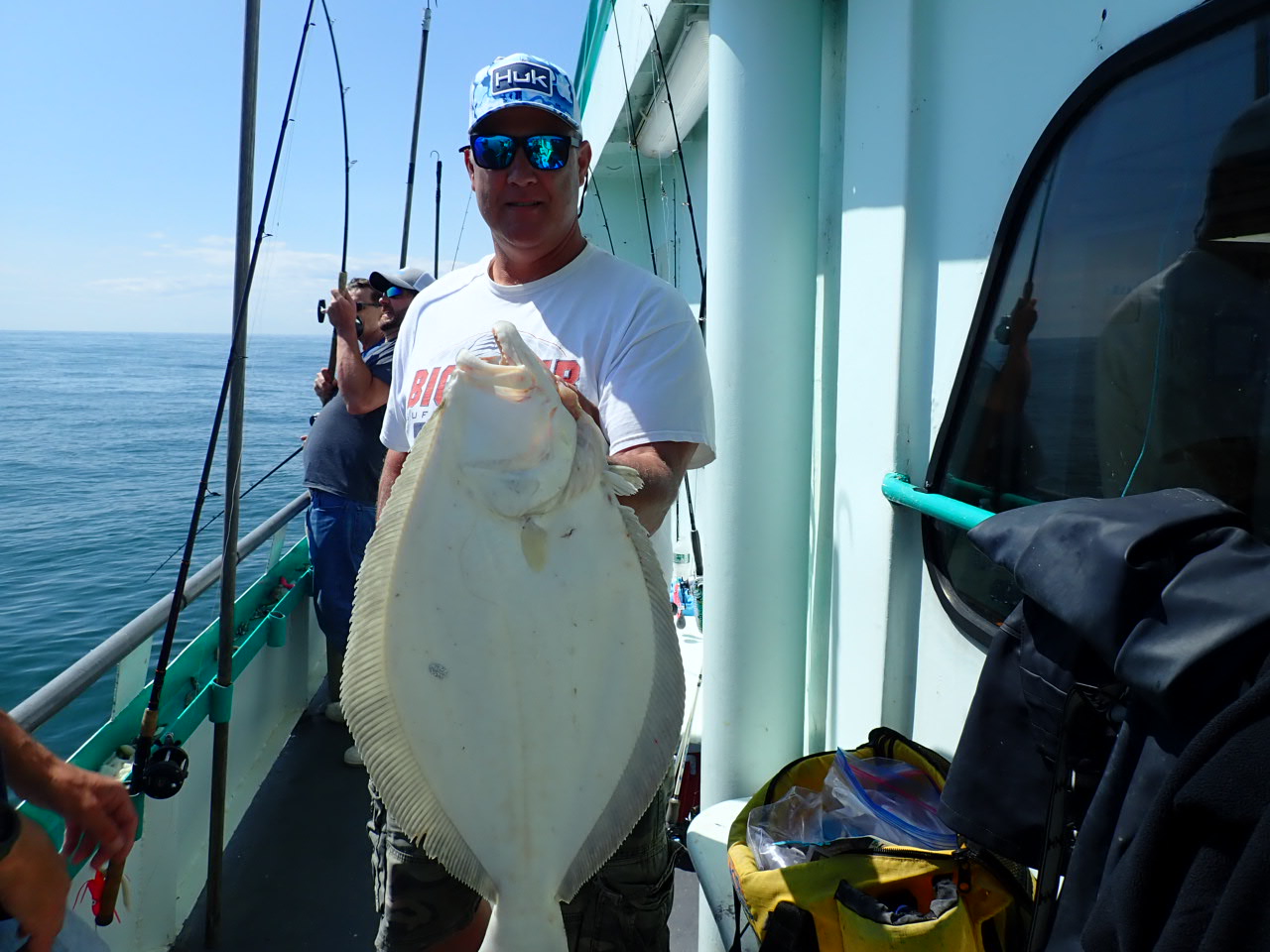 a man holding a fish on a boat