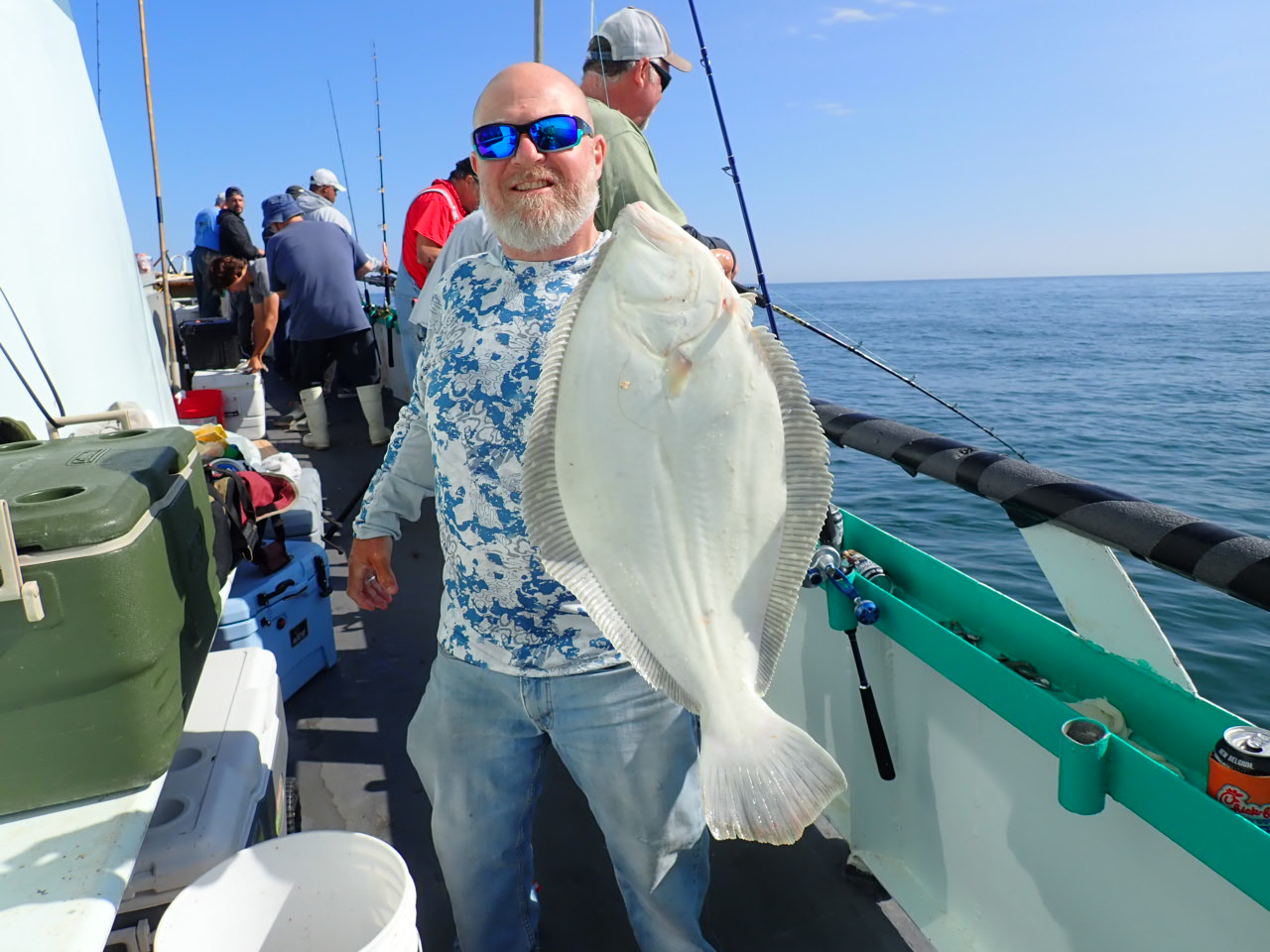 a person holding a fish on a boat
