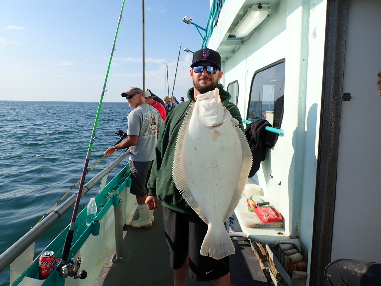 a man holding a fish on a boat