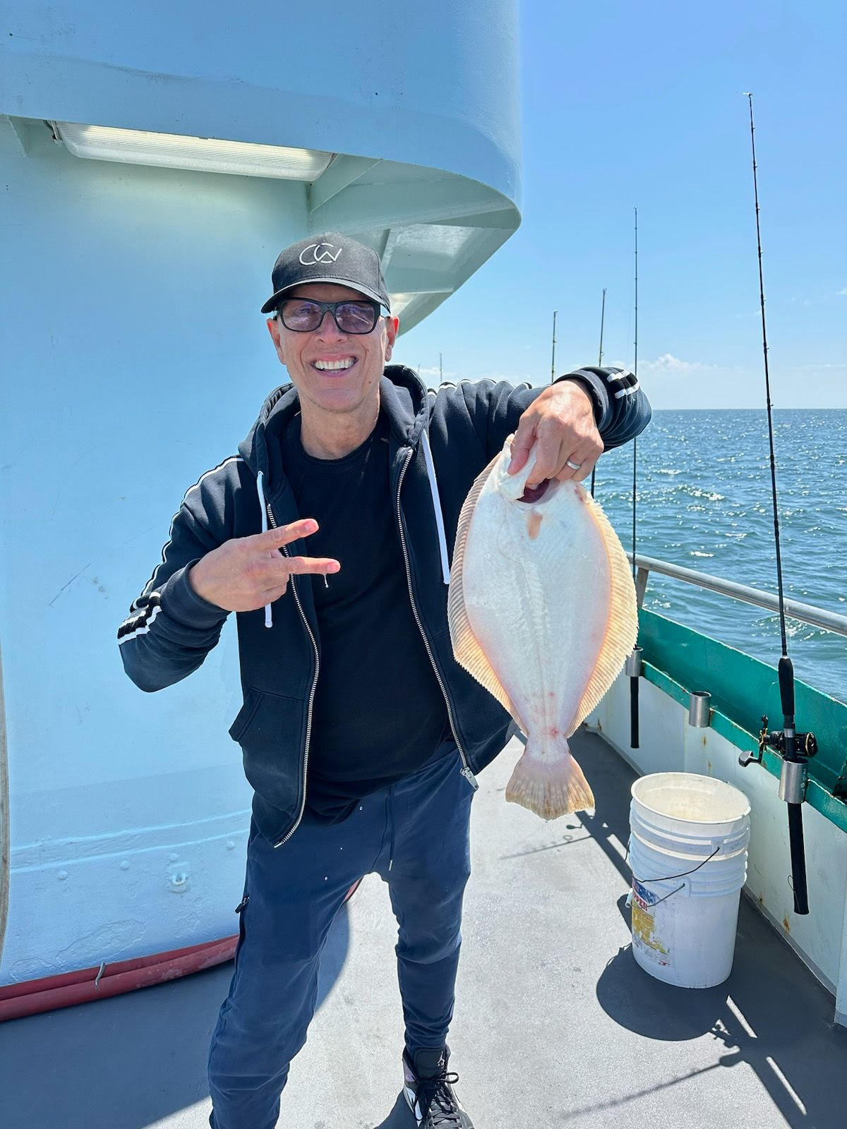 a person holding a fish on a boat