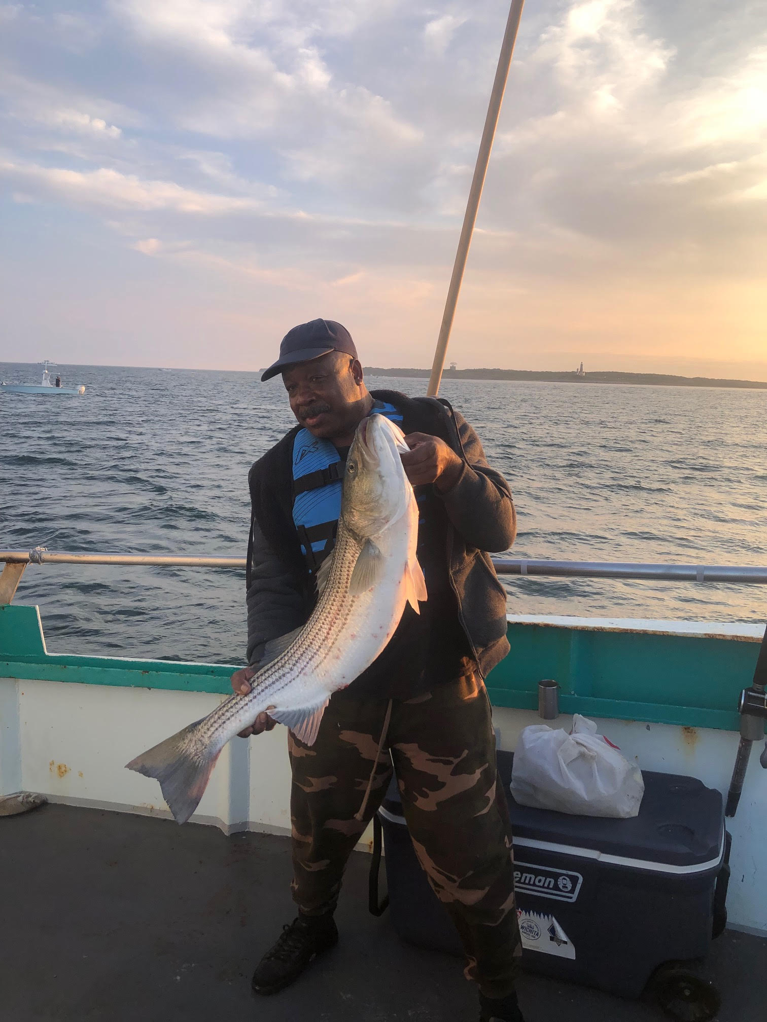 a man holding a fish in the water