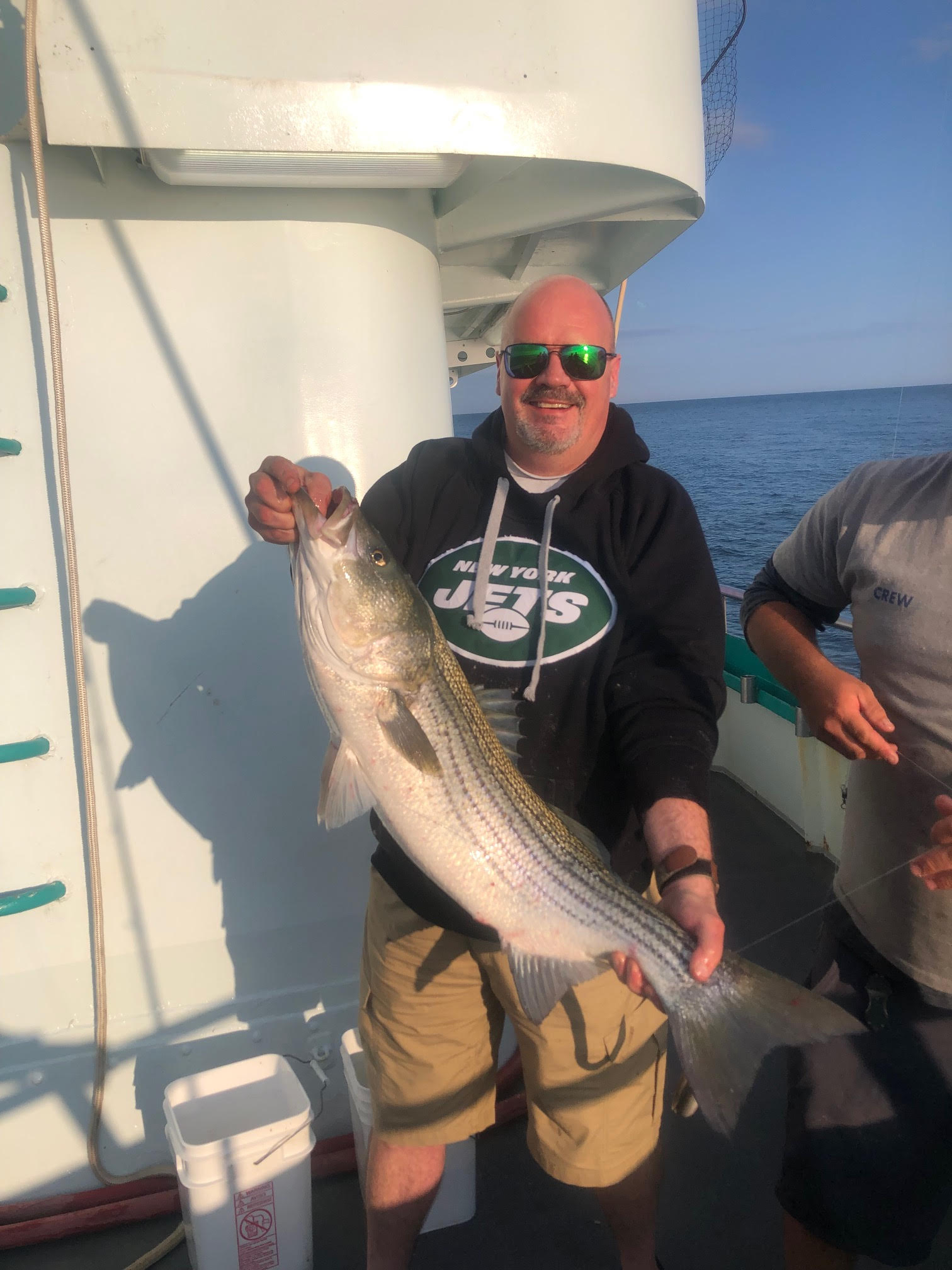 a man holding a fish in the water