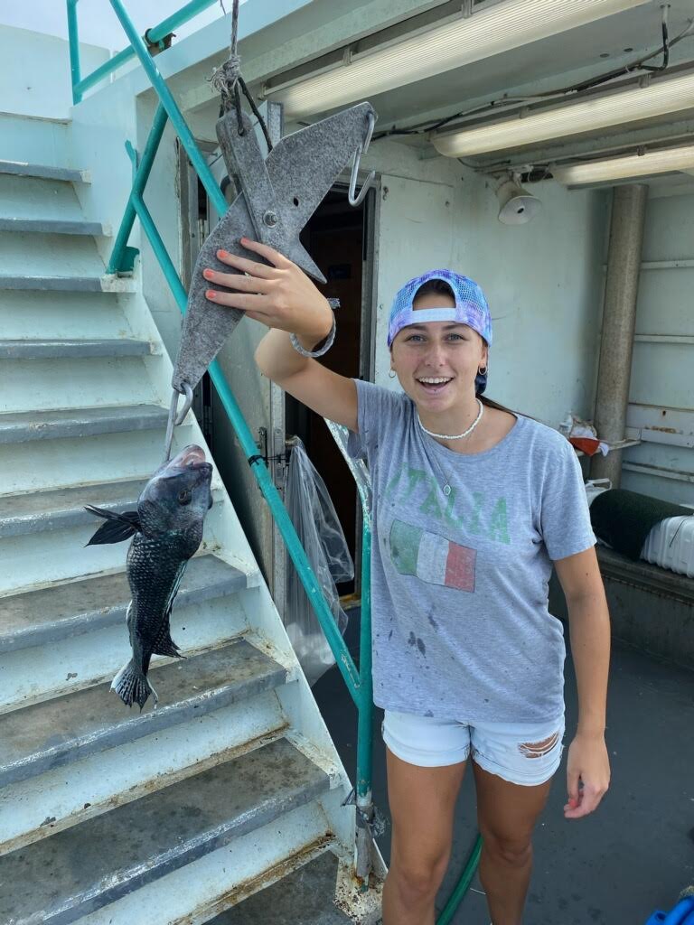 a young boy standing in front of a building