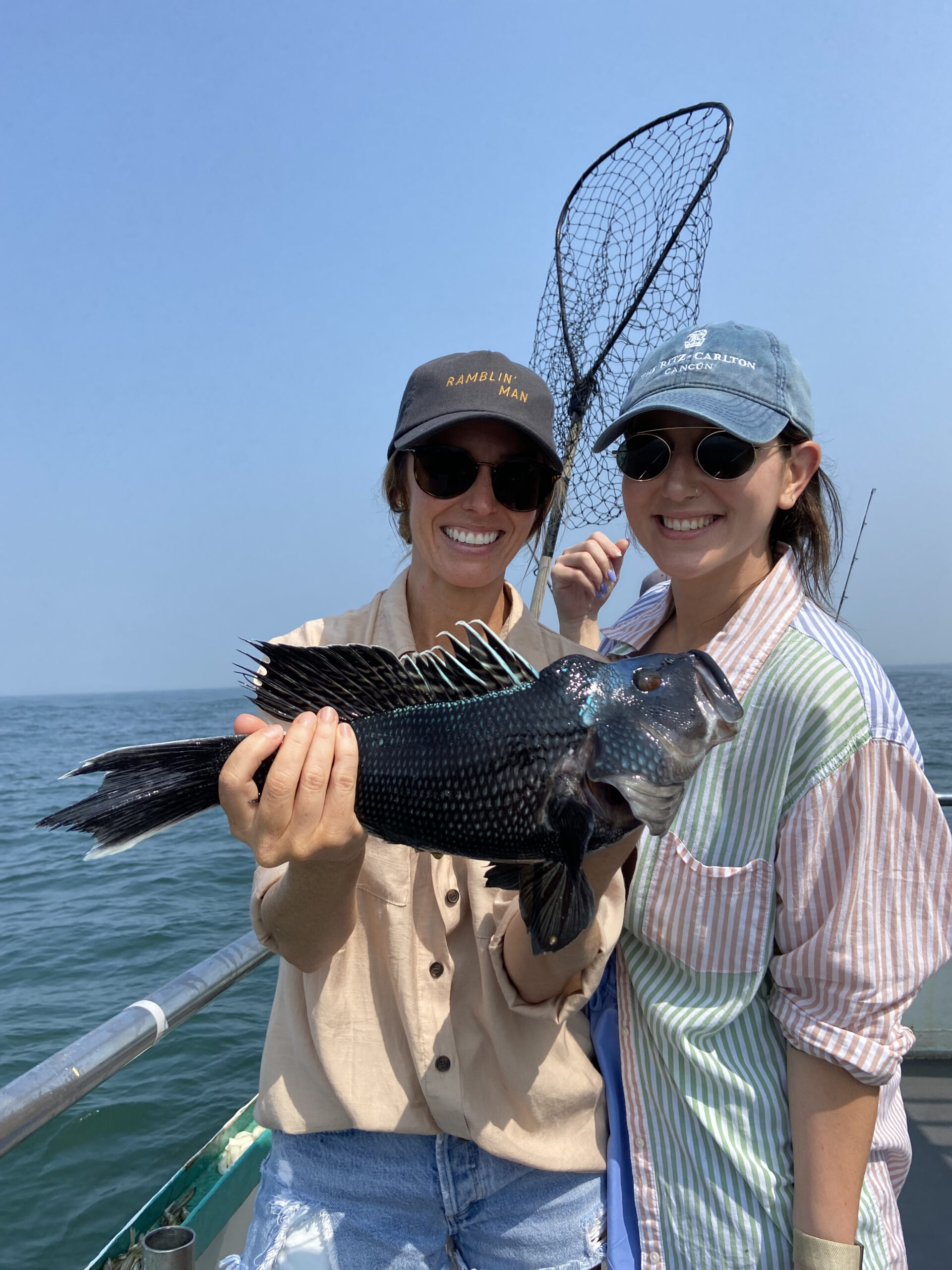 a man and a woman standing next to a body of water