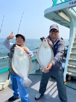 a man and a woman holding a fish