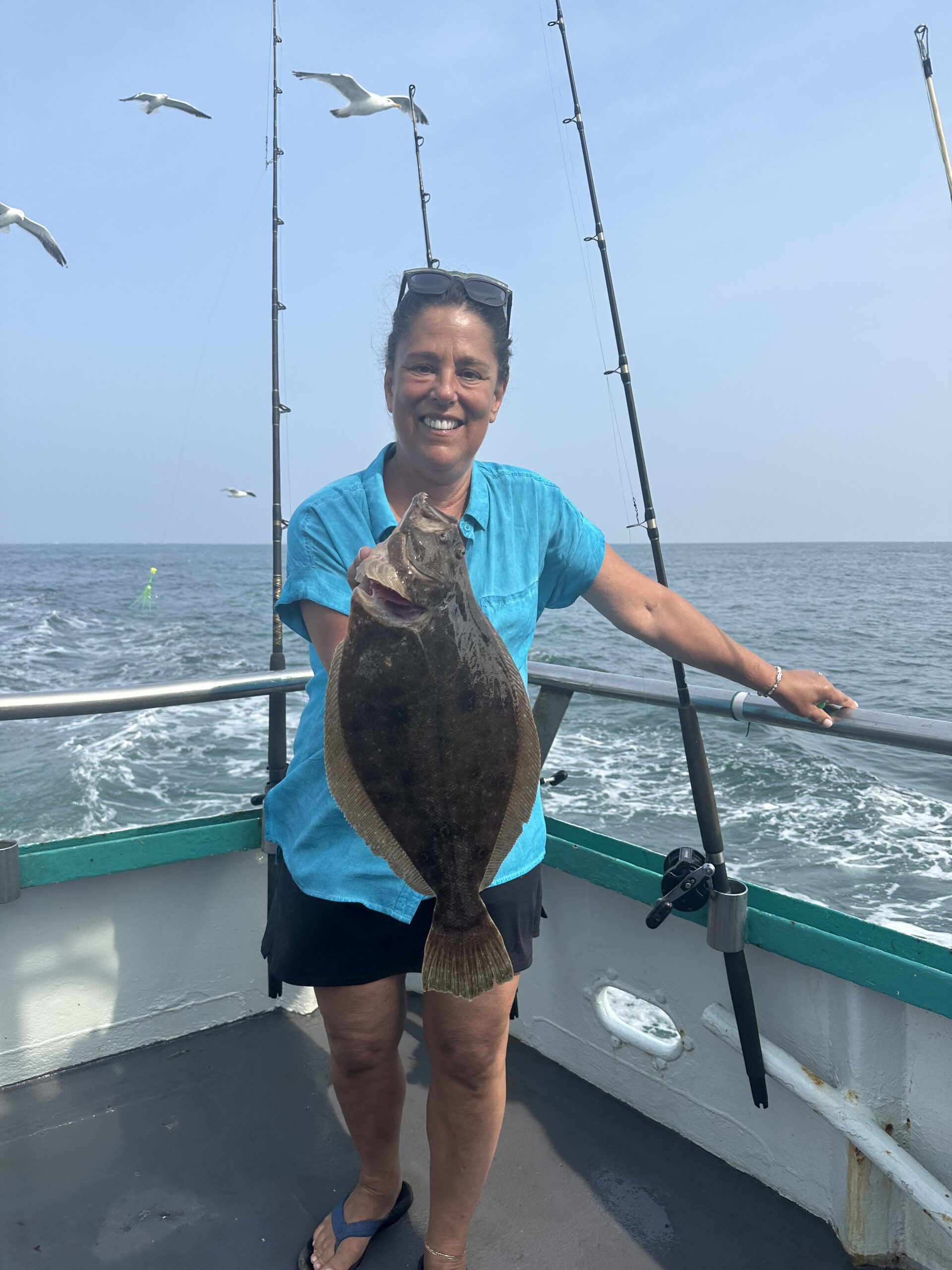 a man standing next to a body of water