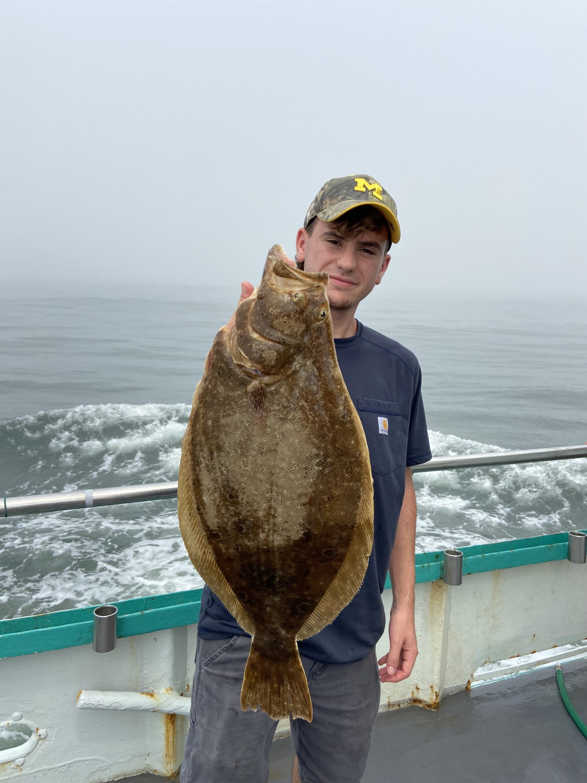 a person holding a fish in the water