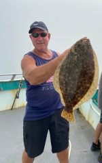 a man holding a fish