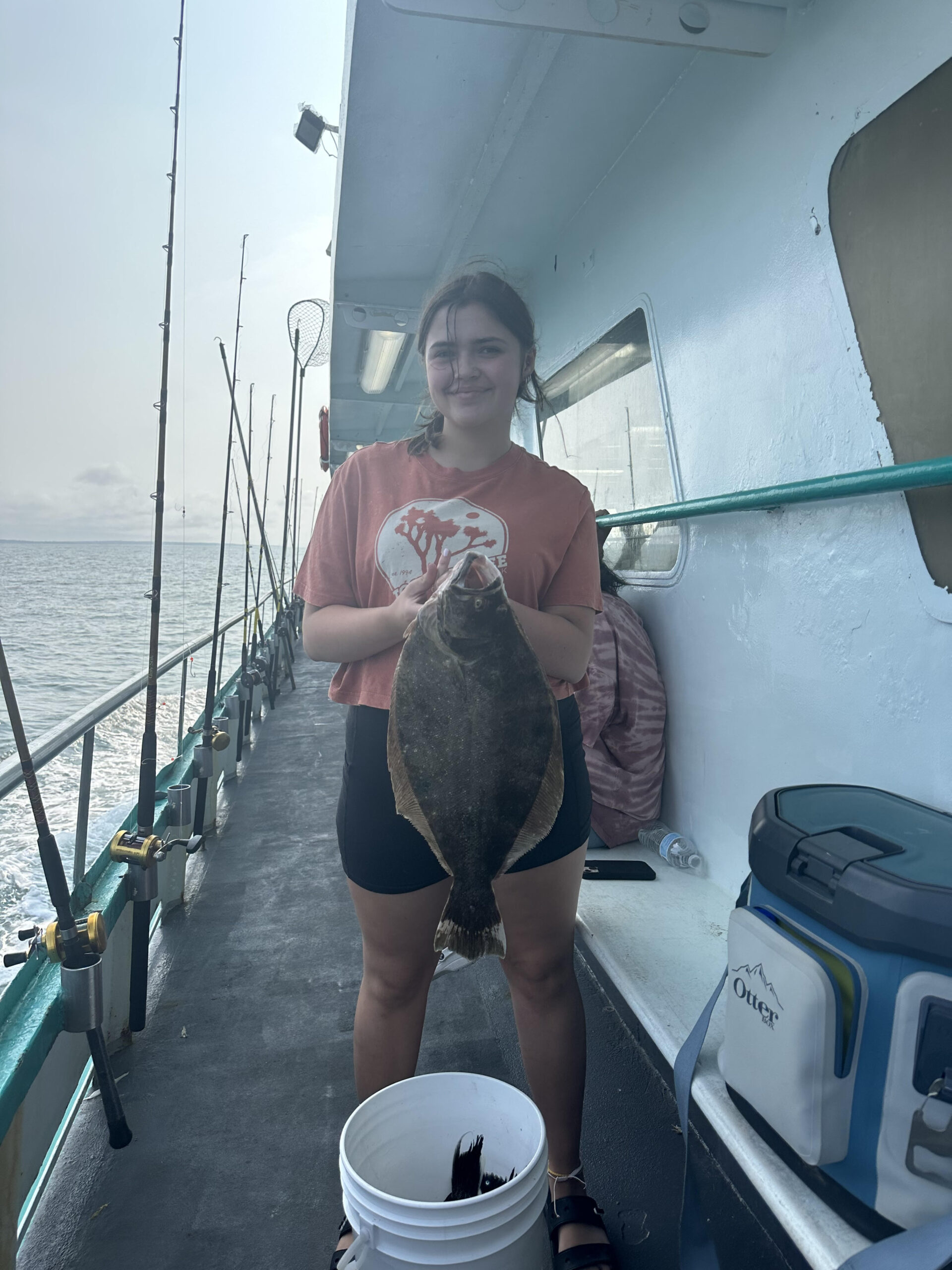 a person holding a fish on a boat