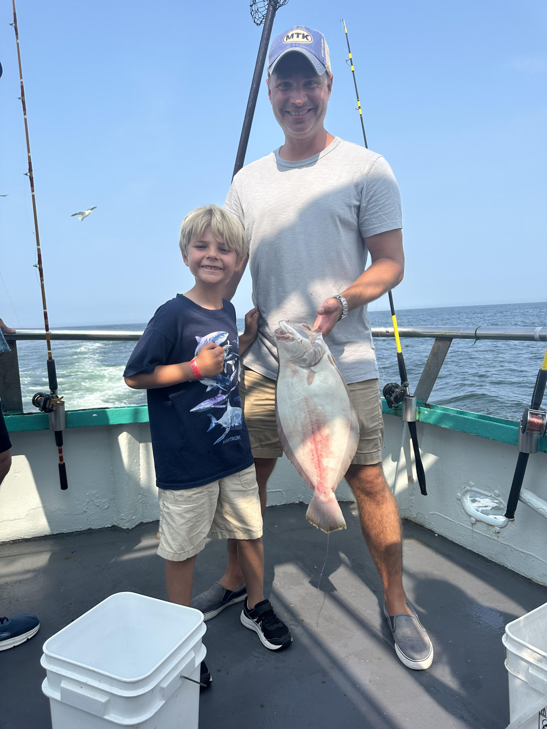 a man holding a fish in the water
