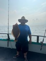a man standing next to a body of water