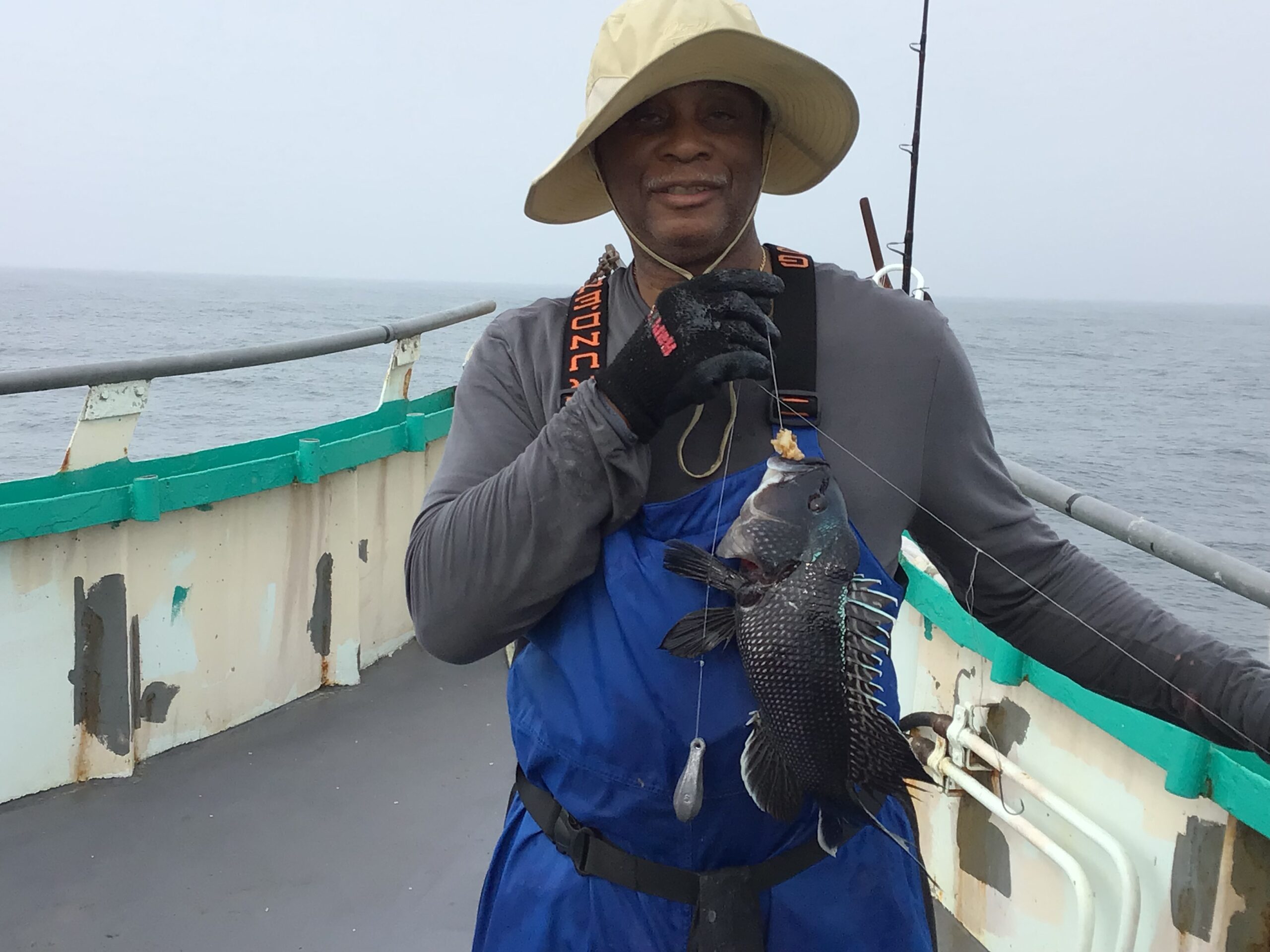 a person holding a fish on a boat