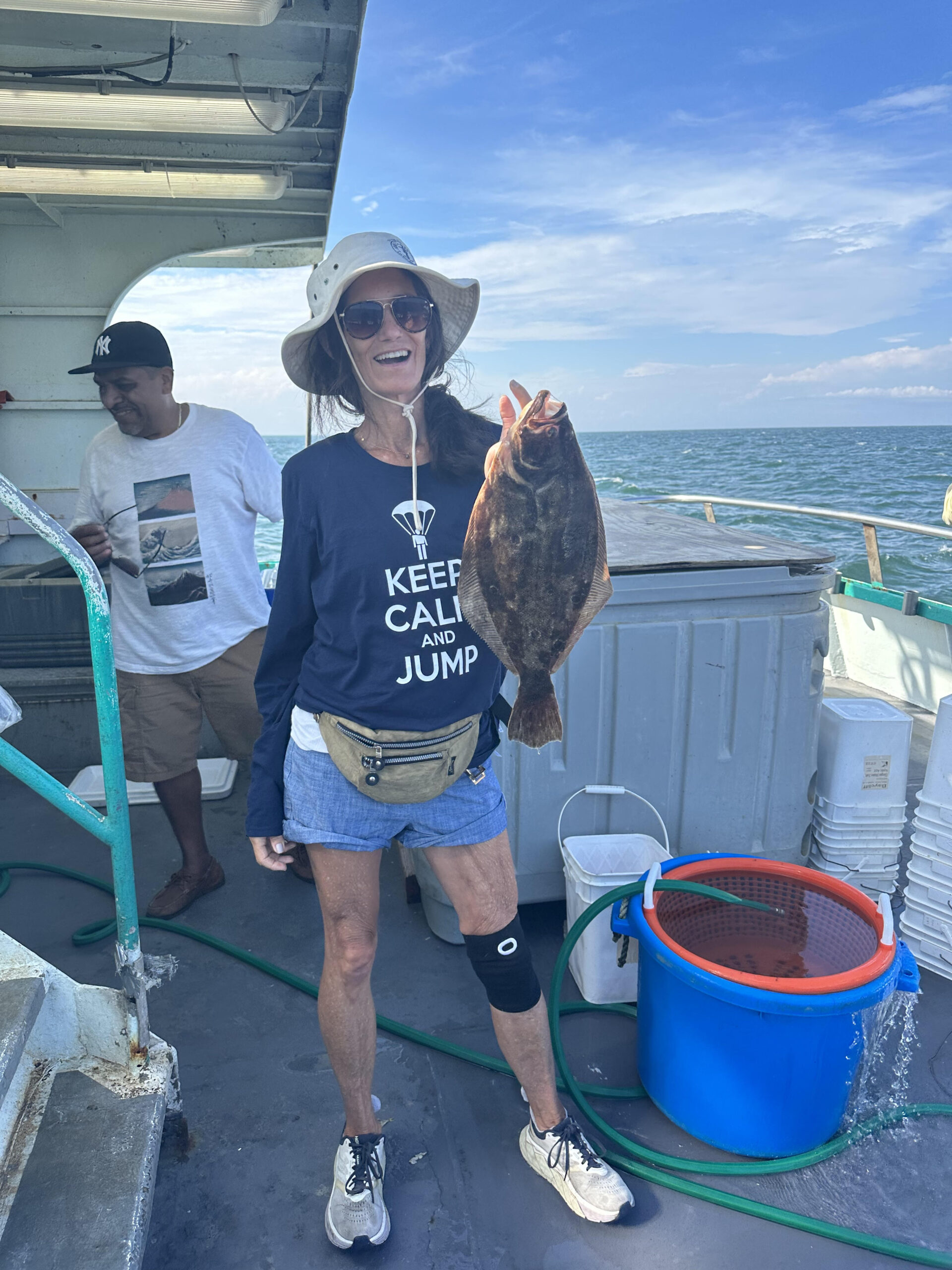 a man holding a fish on a boat