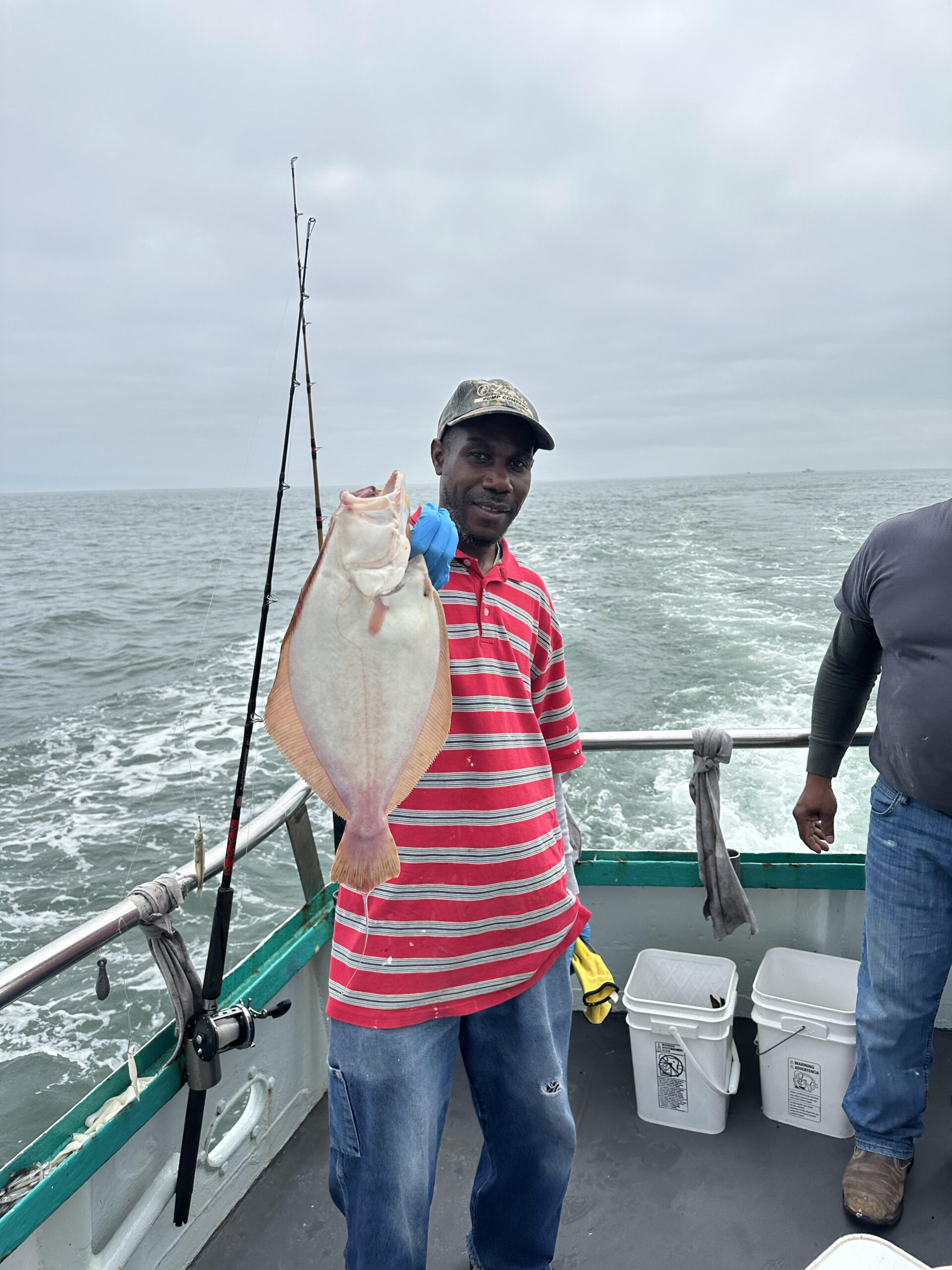 a person standing next to a body of water