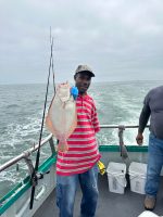 a person standing next to a body of water