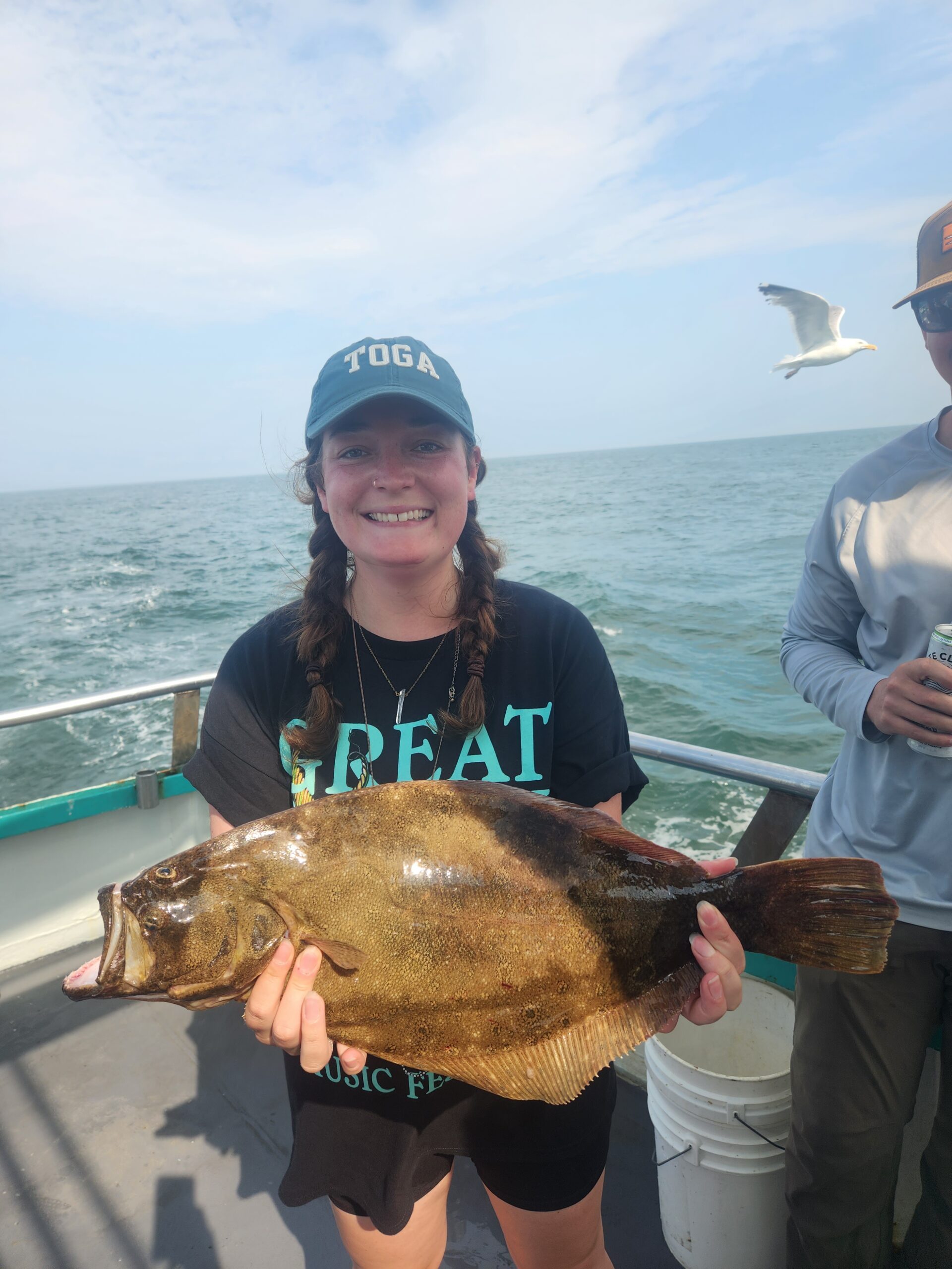 a person standing next to a body of water