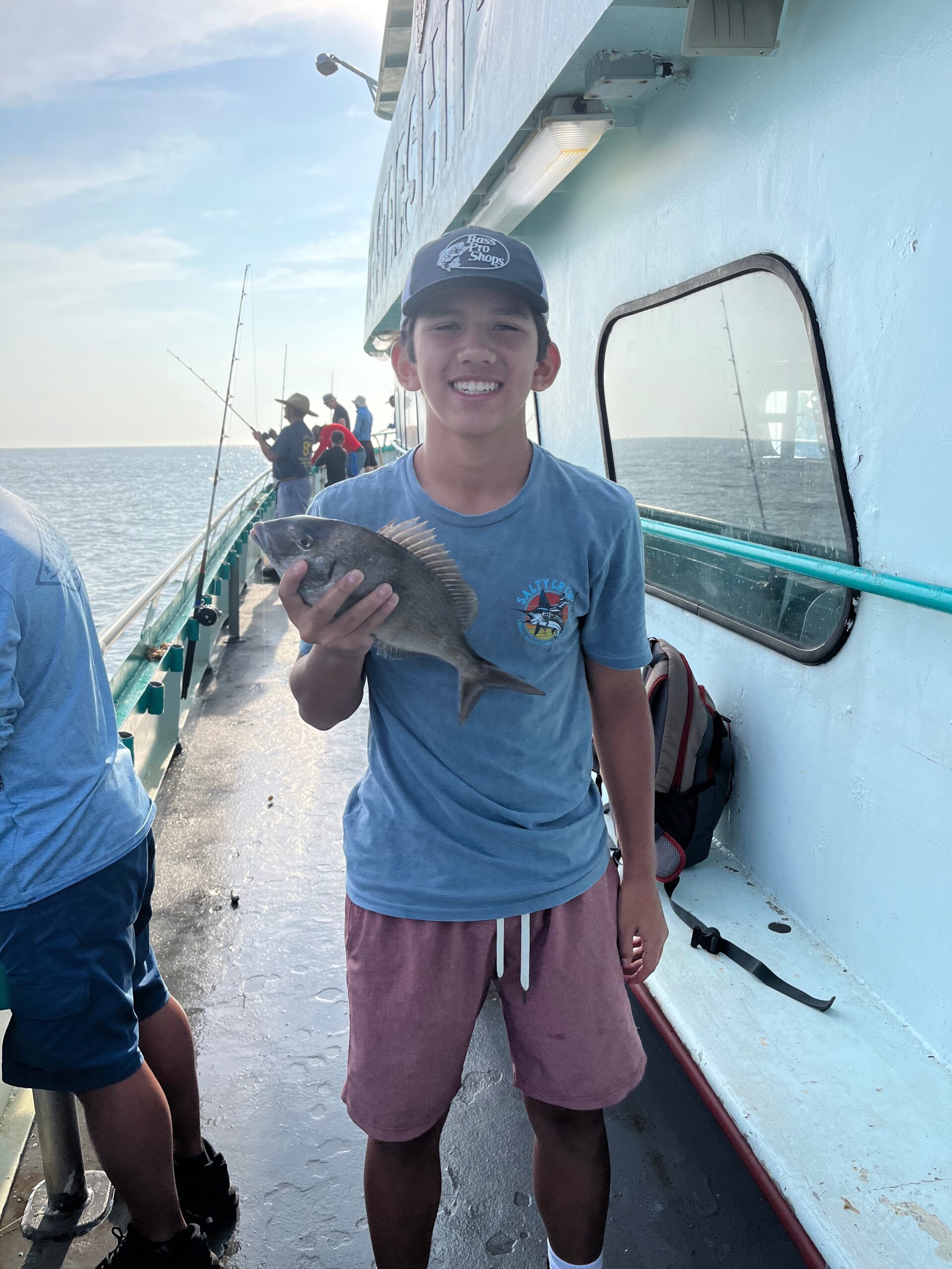 a man and a woman standing on a boat