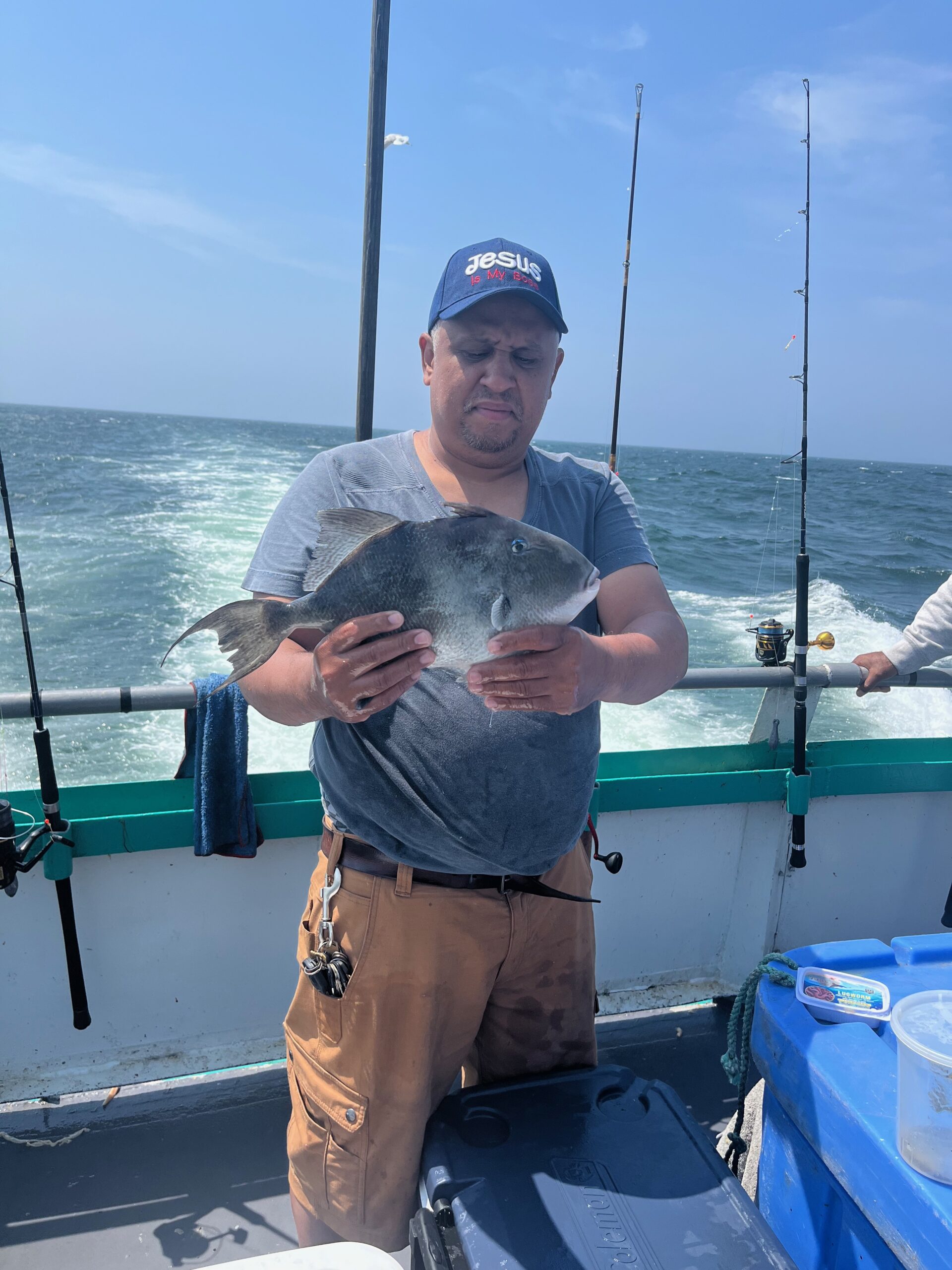 a person holding a fish on a boat in the water