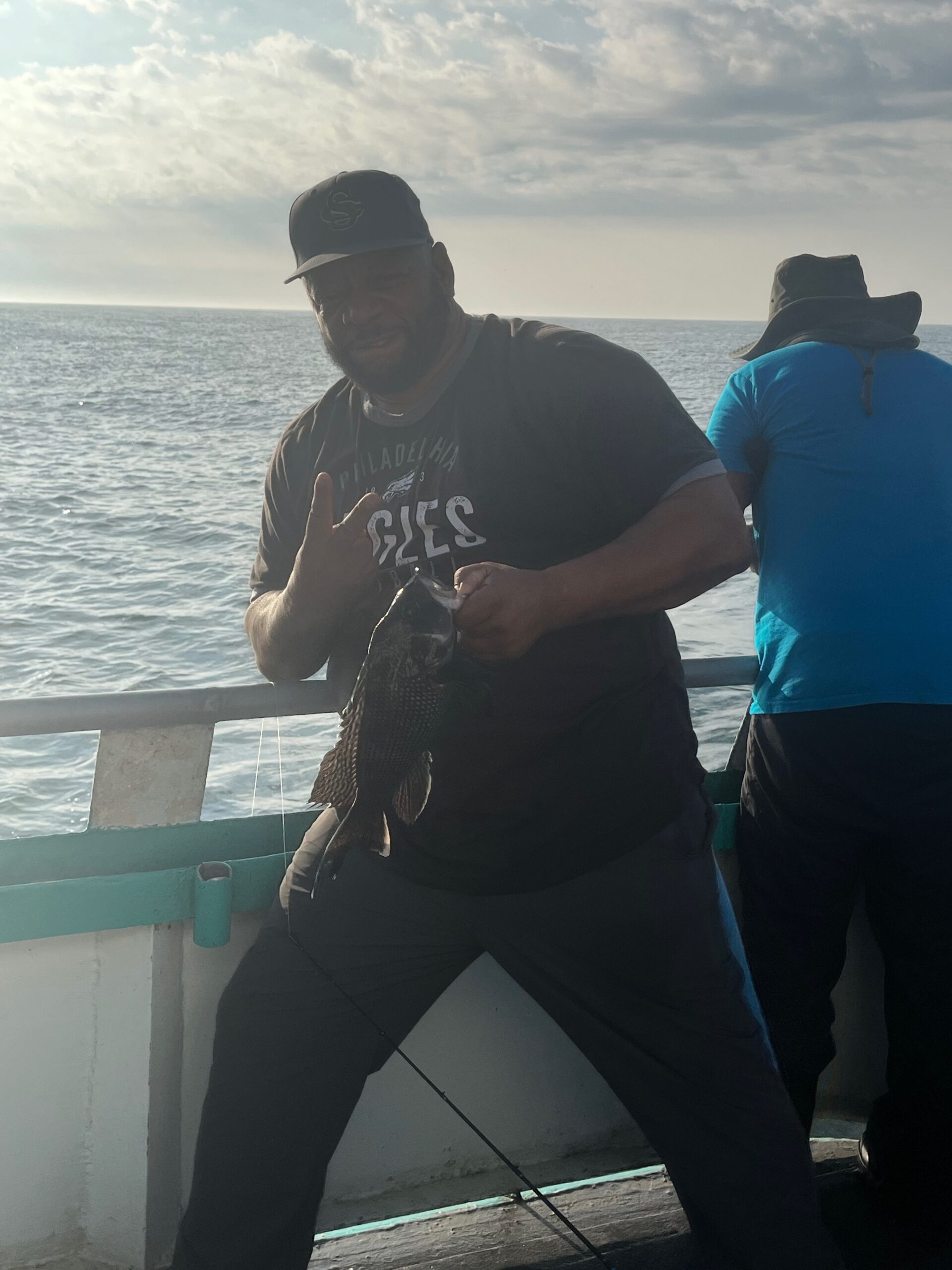 a man and a woman standing next to a body of water