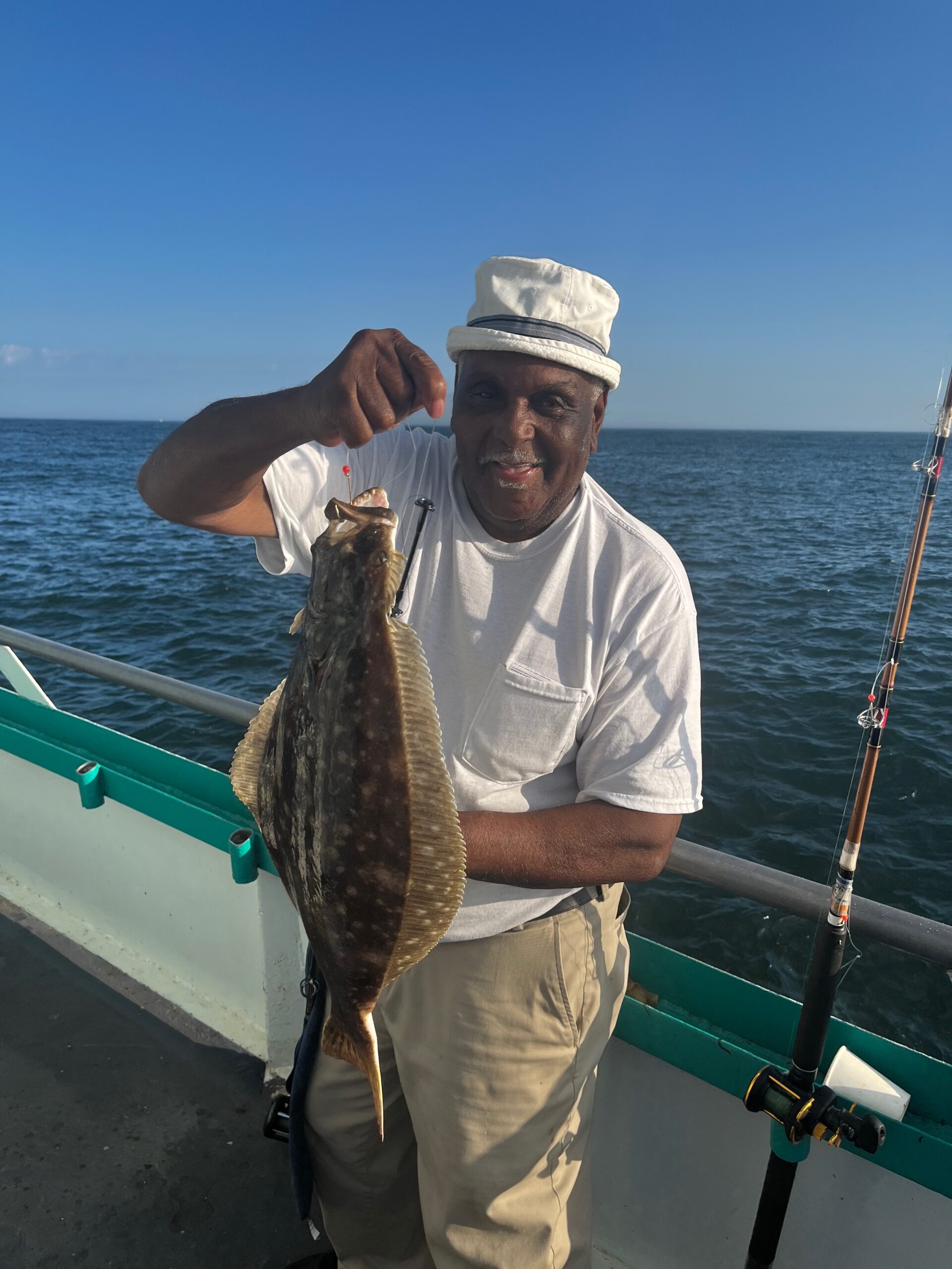 a man holding a fish in the water