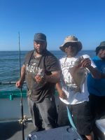 a group of people standing on a boat in the water