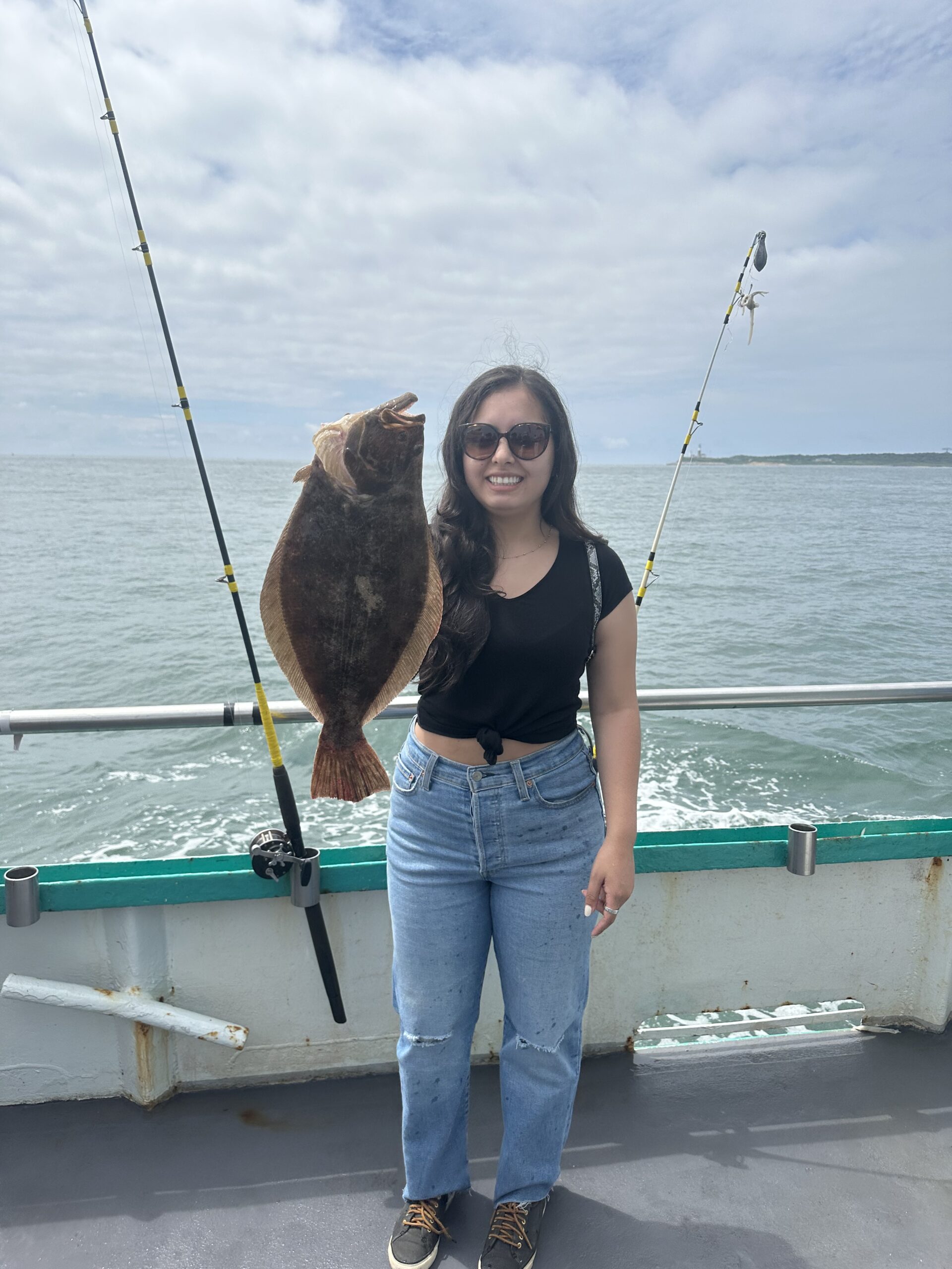 a person standing next to a body of water