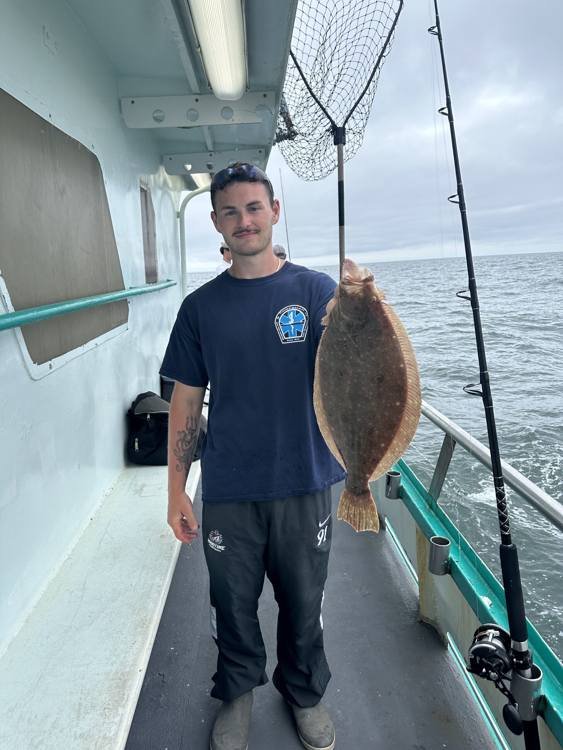 a person holding a fish on a boat in the water