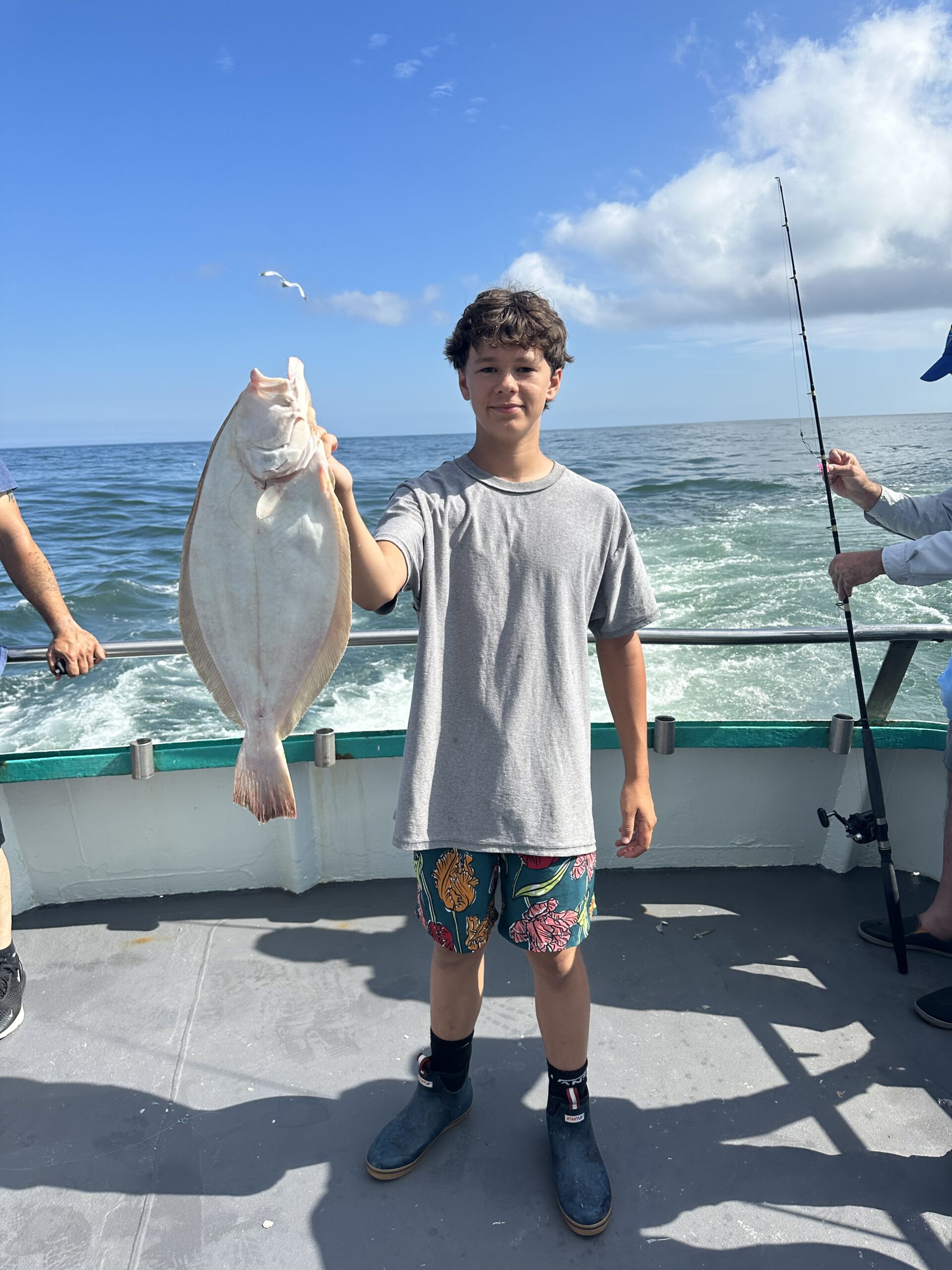 a man holding a fish in the water