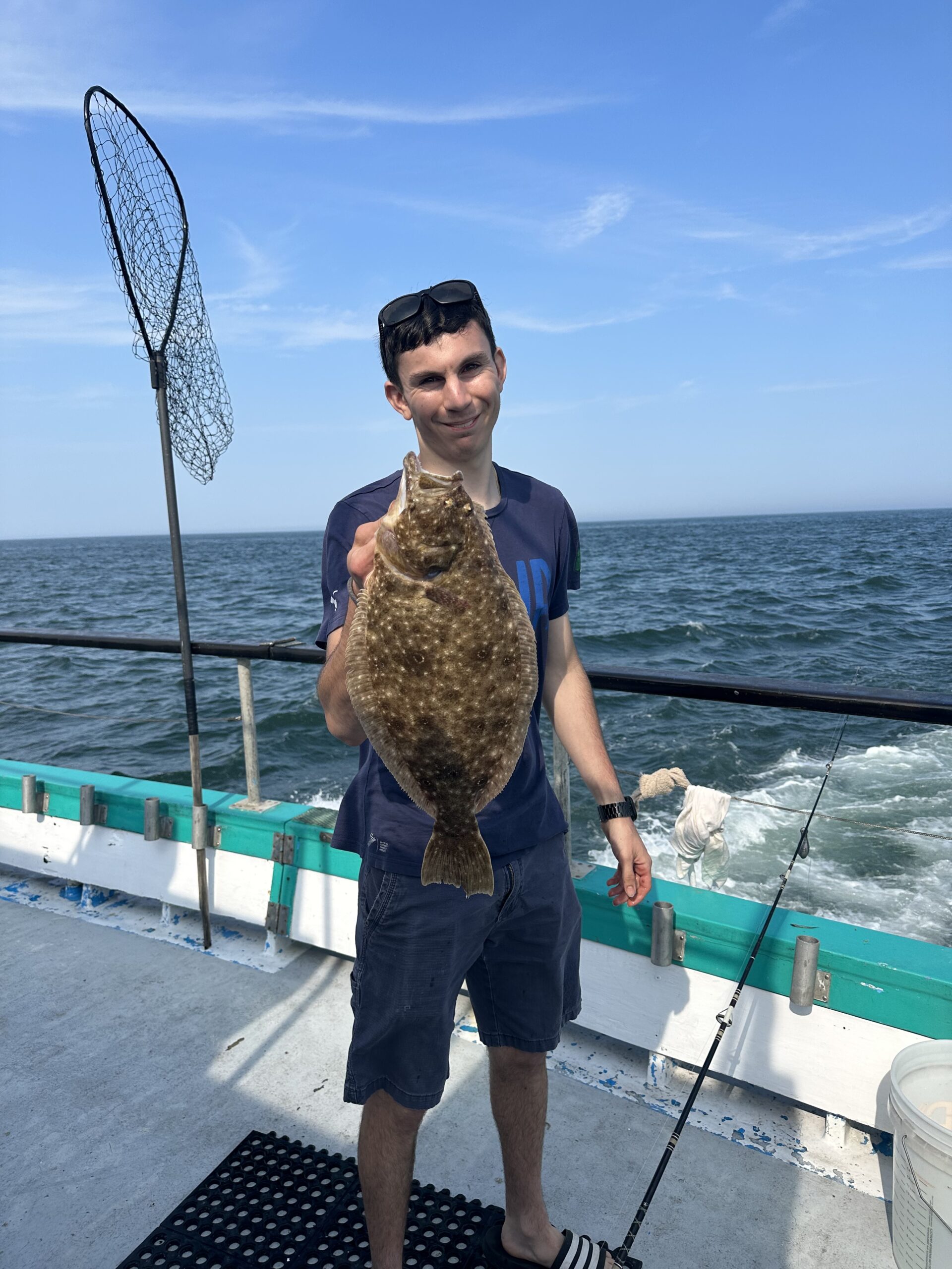 a man standing next to a body of water