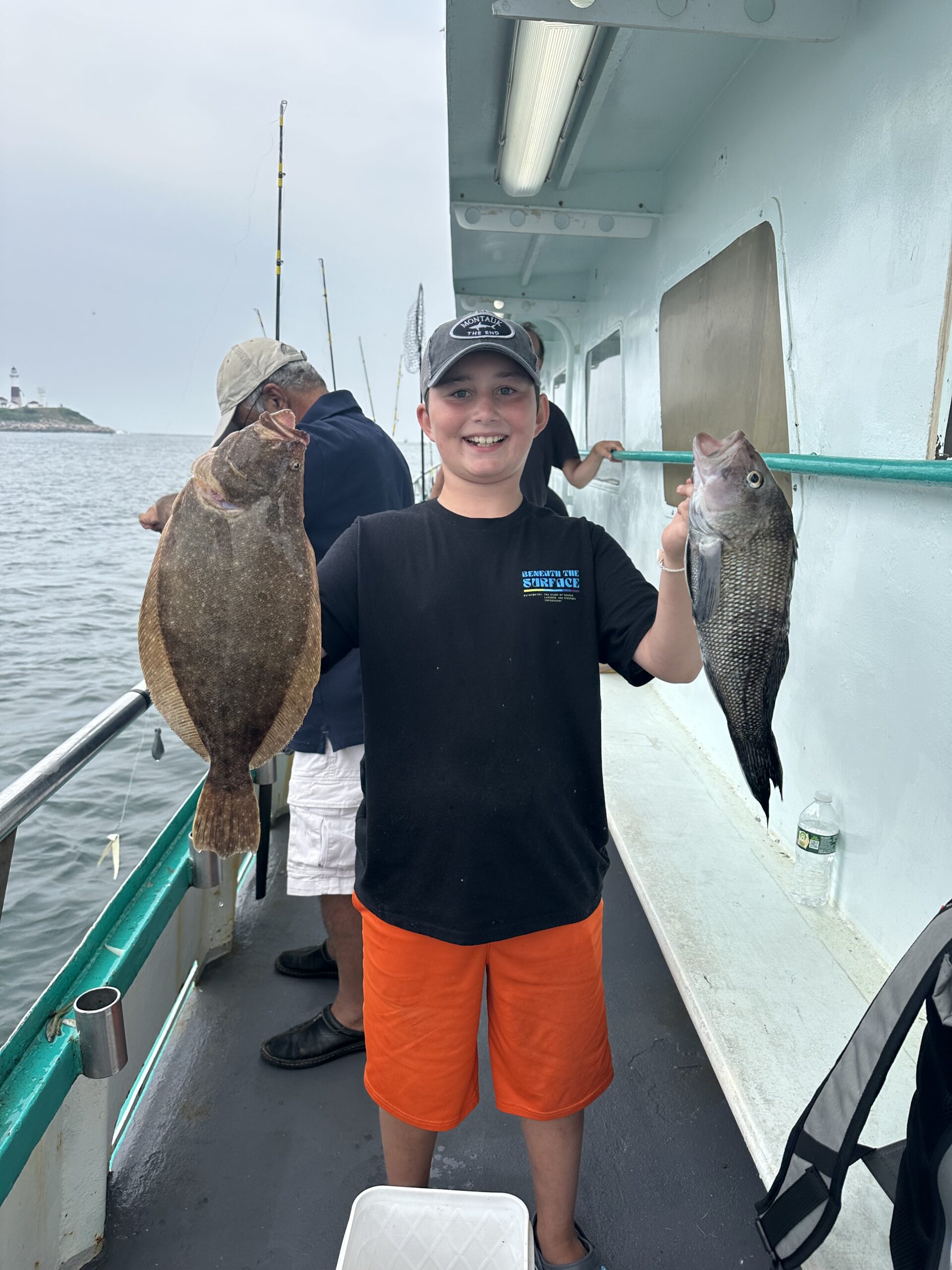 a man holding a fish on a boat