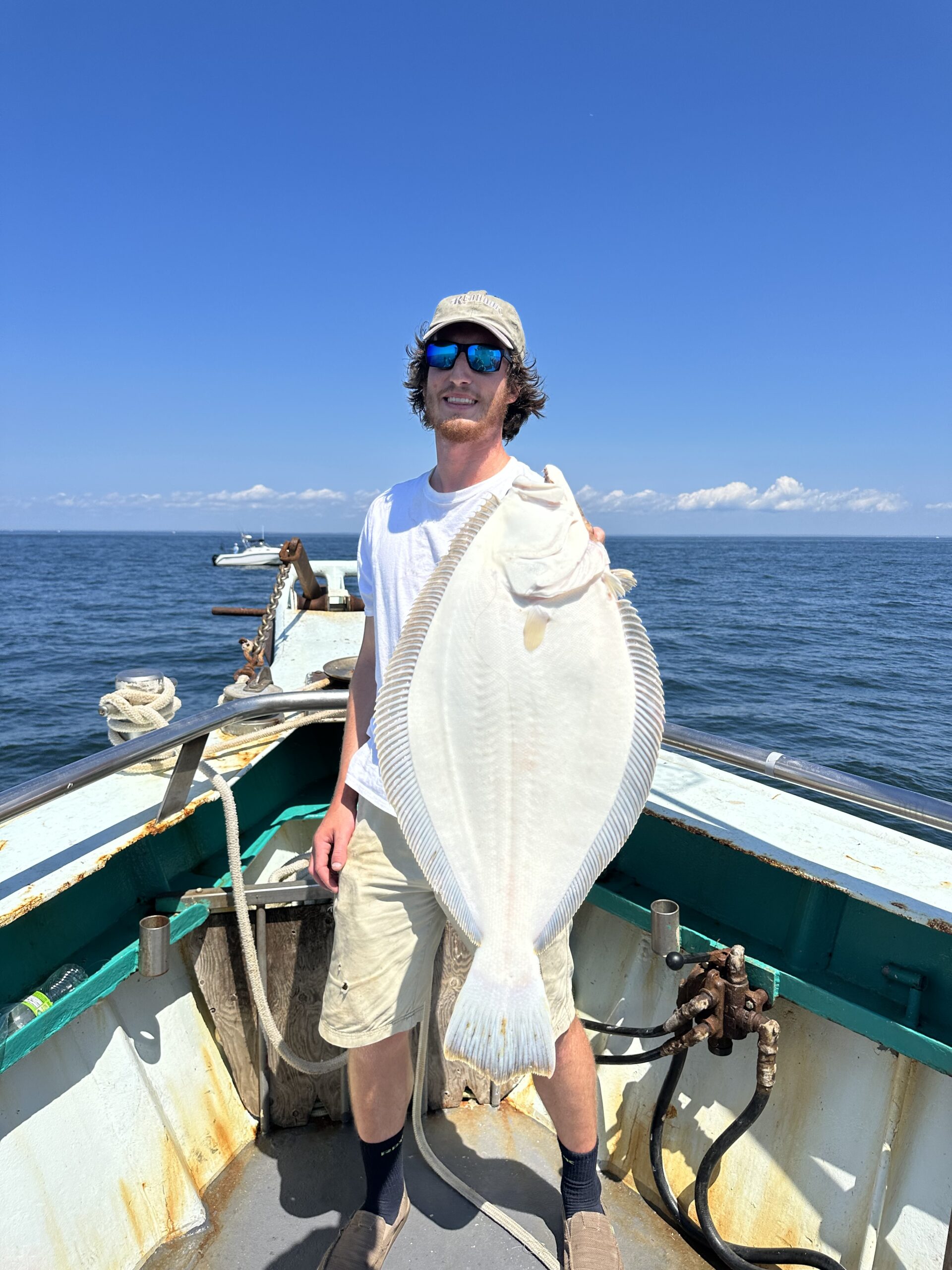 a person standing next to a body of water
