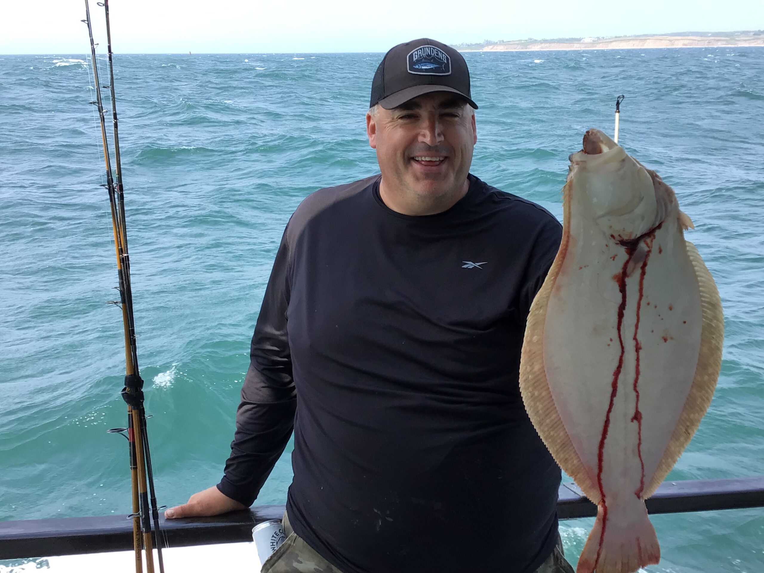 a person holding a fish on a boat in a body of water