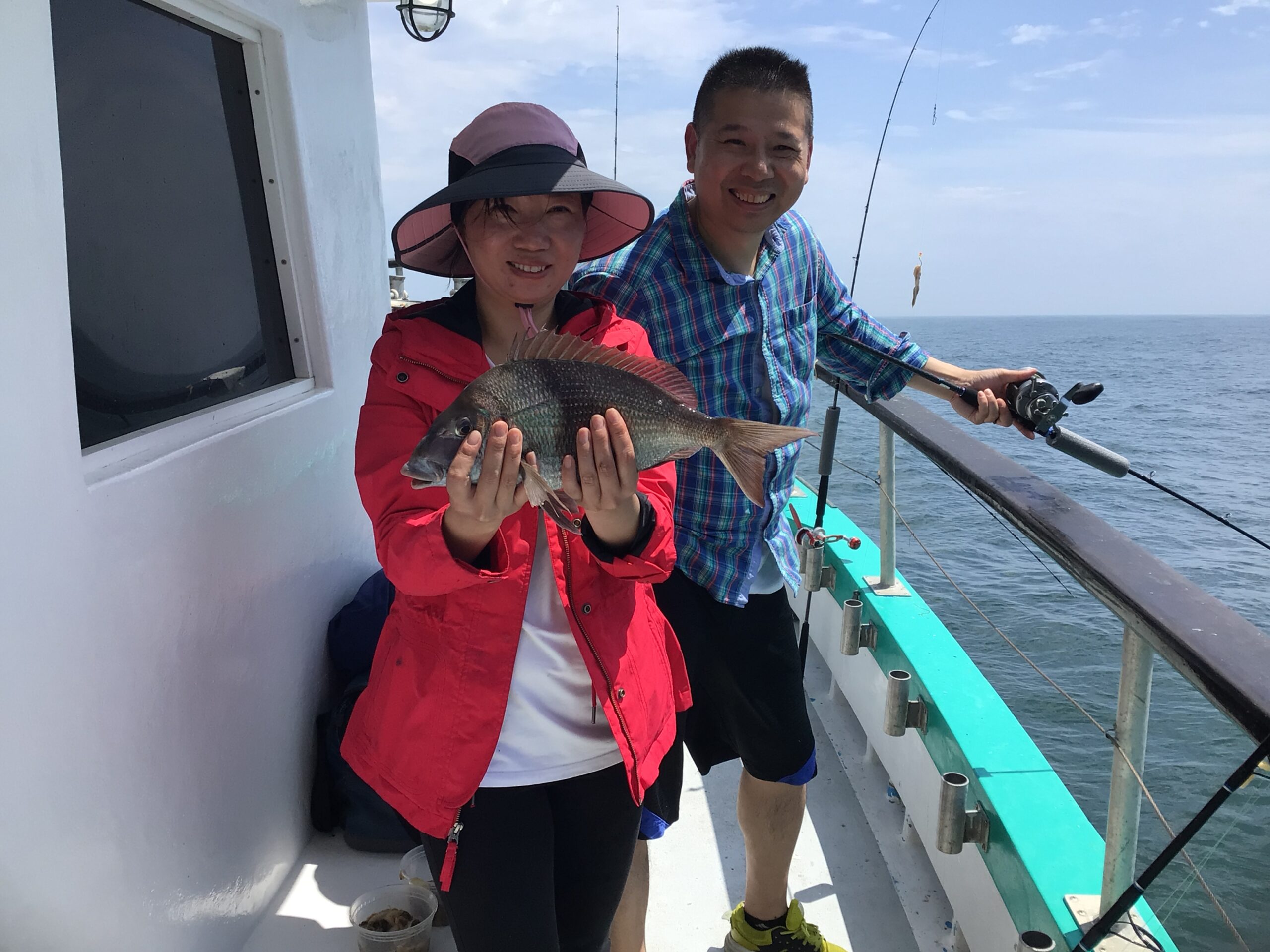 Melvin Tan et al. standing next to a body of water