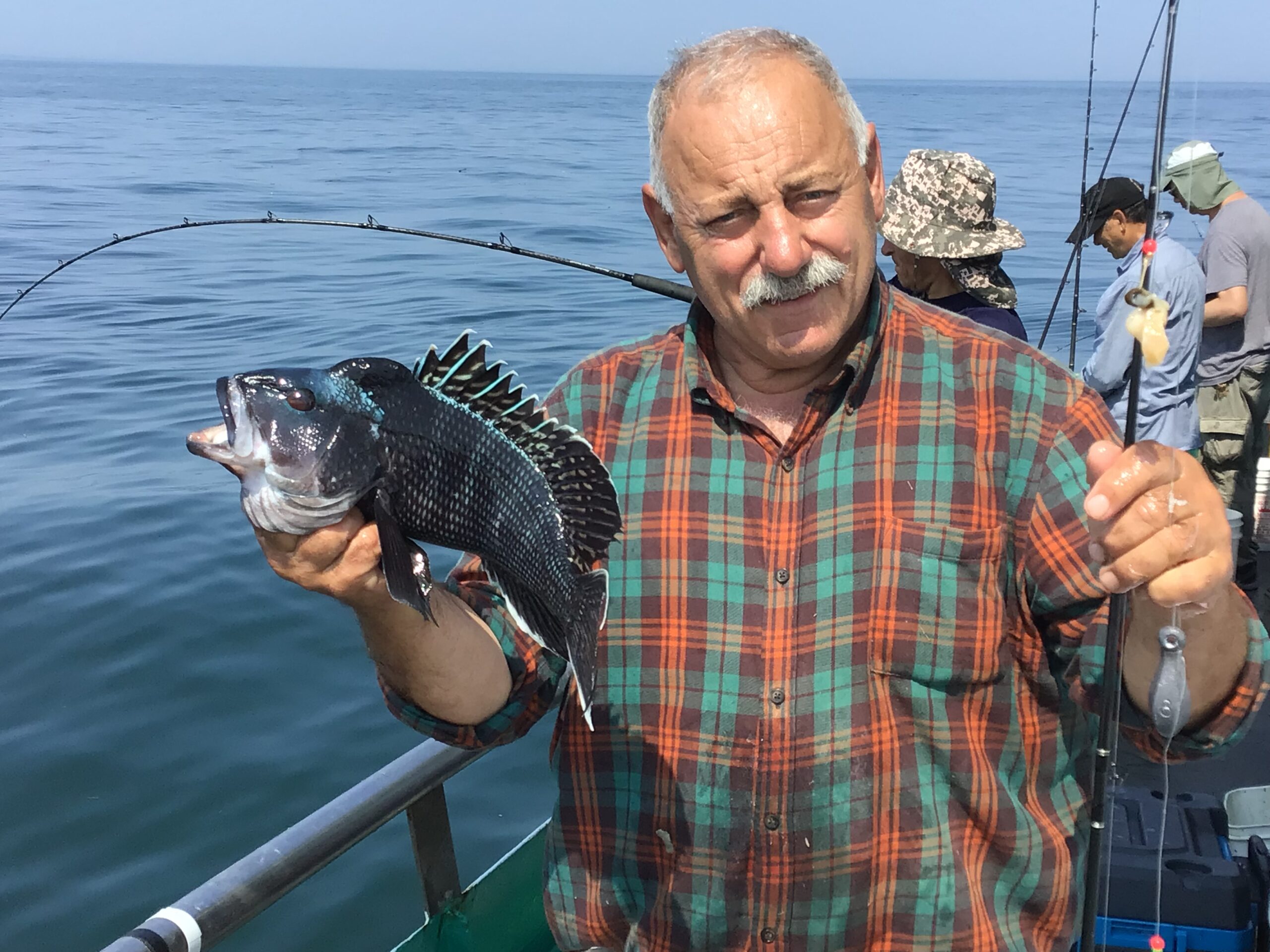 a man holding a fish in the water
