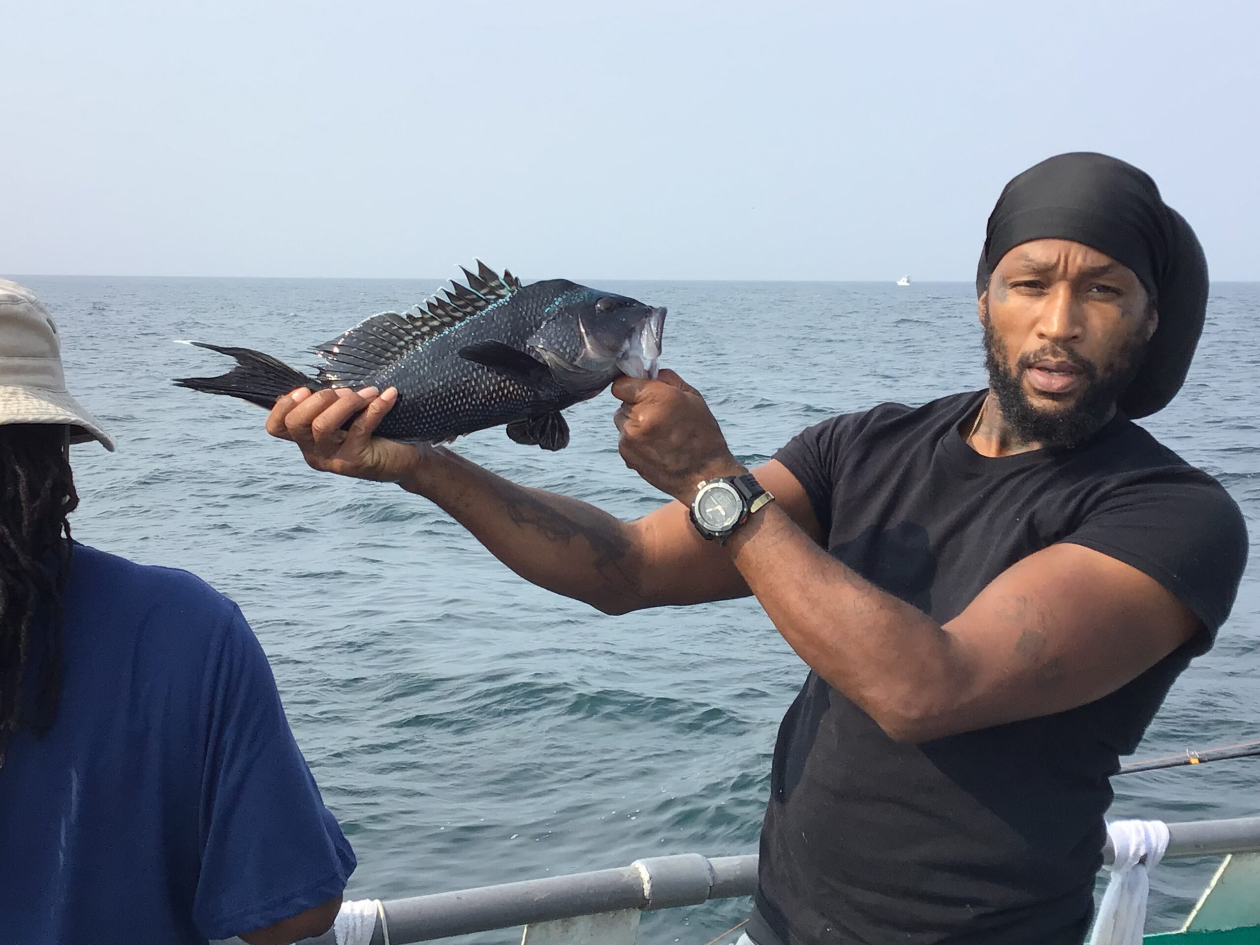 Lorenzo Neal holding a fish in the water